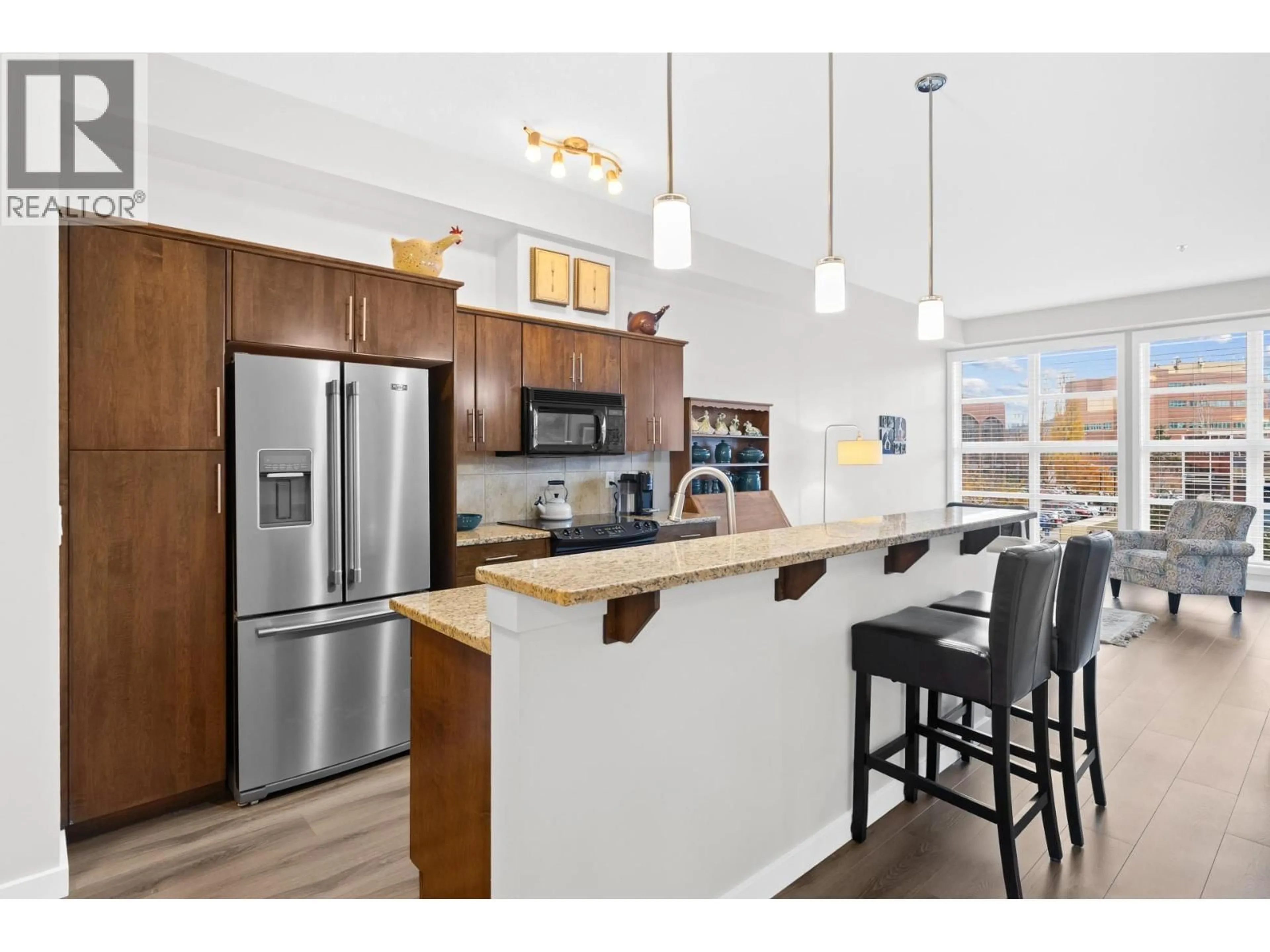 Open concept kitchen, wood/laminate floor for 221 - 1331 ELLIS STREET, Kelowna British Columbia V1Y1Z9
