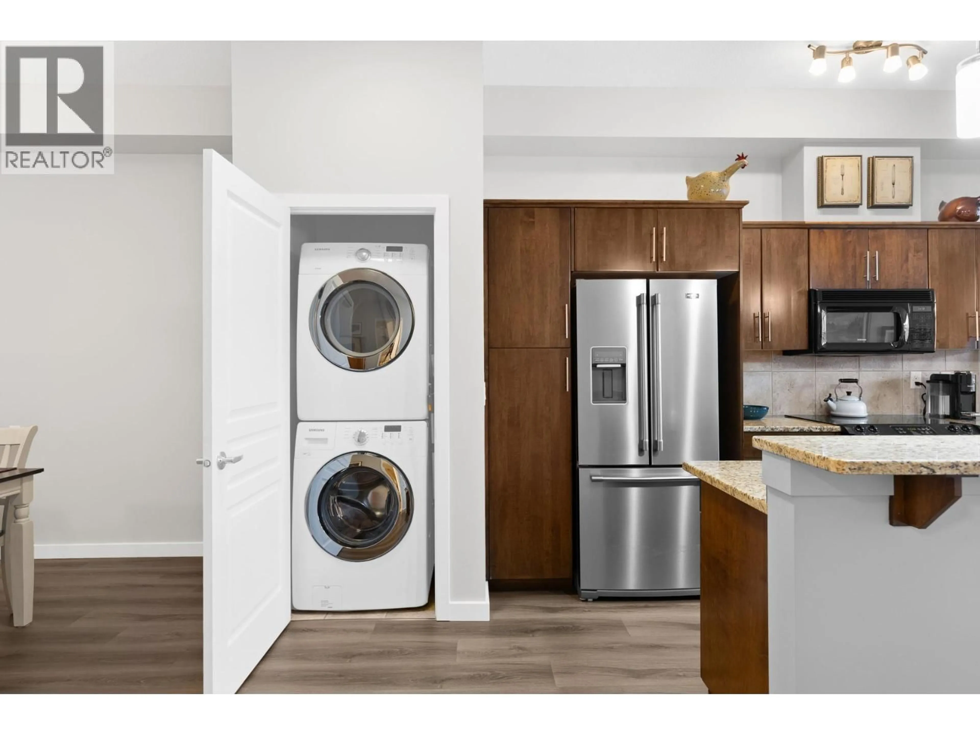 Kitchen with laundary machines, wood/laminate floor for 221 - 1331 ELLIS STREET, Kelowna British Columbia V1Y1Z9