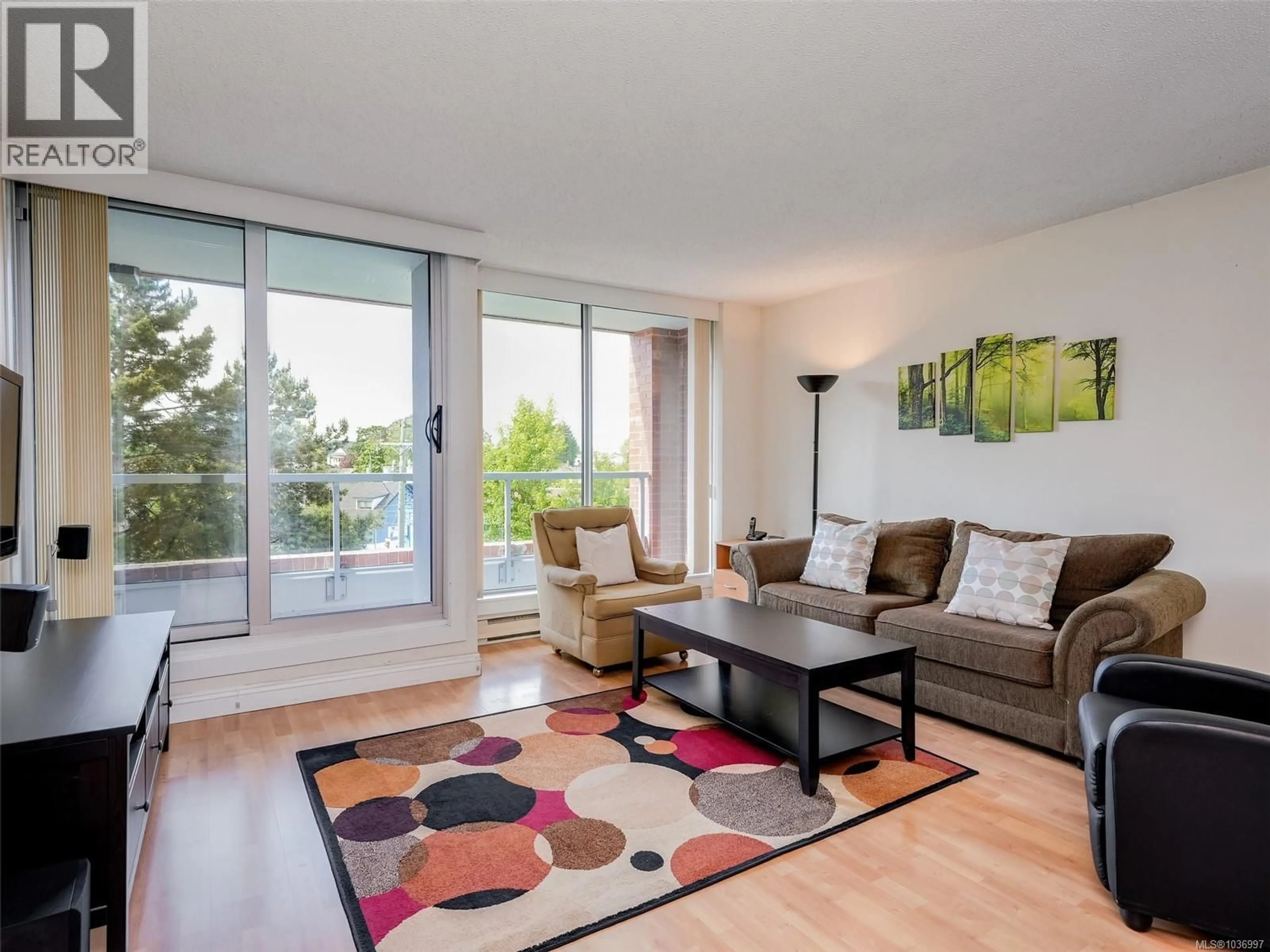 Living room with furniture, wood/laminate floor for 501 - 327 MAITLAND STREET, Victoria British Columbia V9A7G7