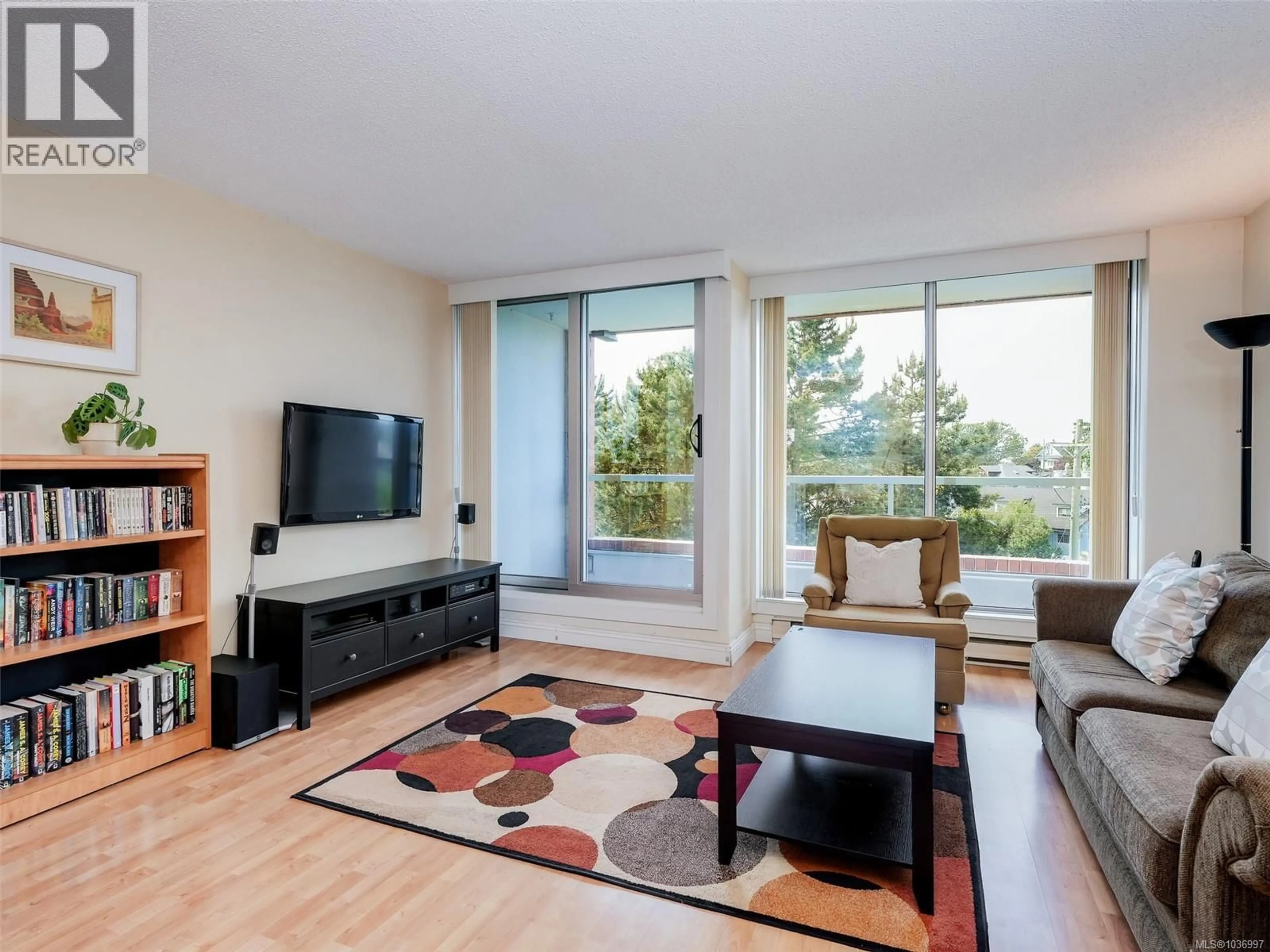 Living room with furniture, wood/laminate floor for 501 - 327 MAITLAND STREET, Victoria British Columbia V9A7G7
