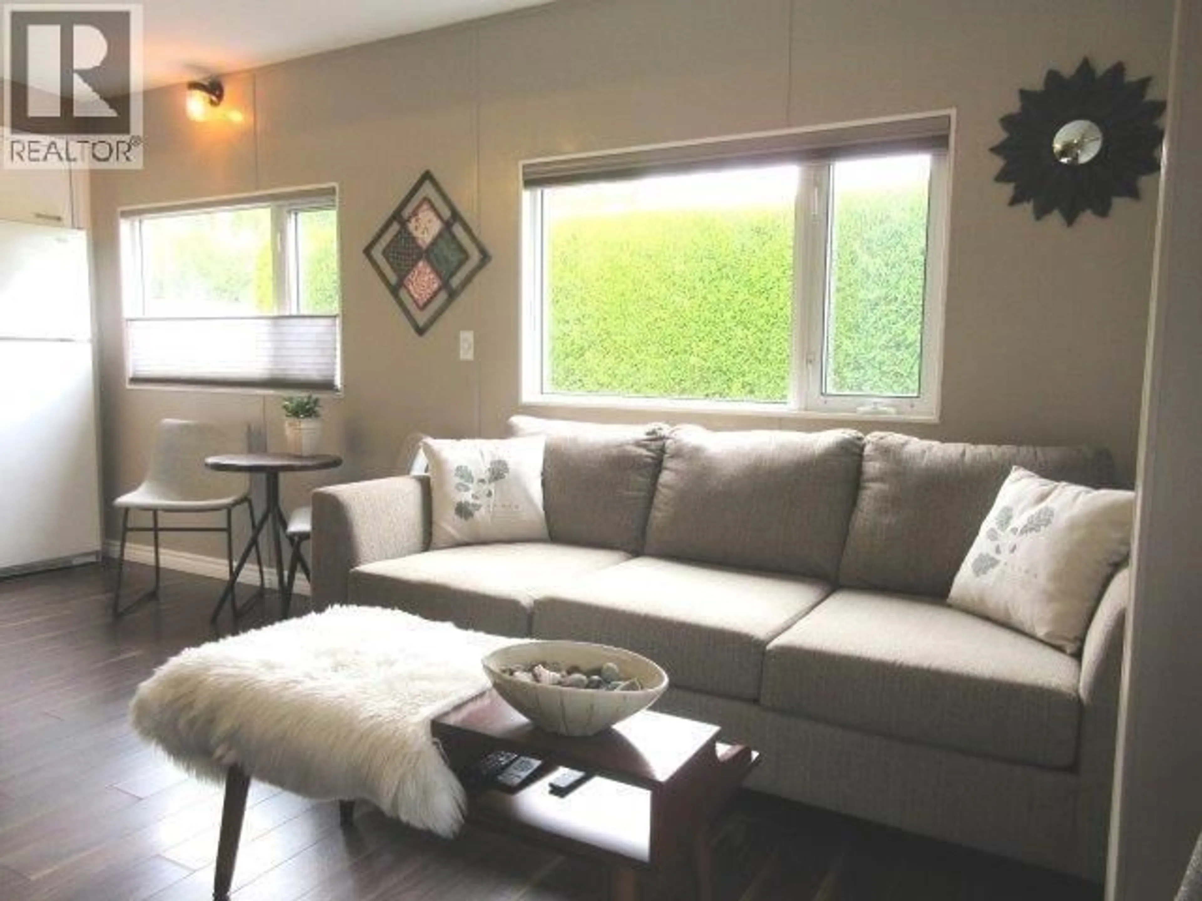 Living room with furniture, wood/laminate floor for 68 - 415 COMMONWEALTH ROAD, Kelowna British Columbia V4V1P4