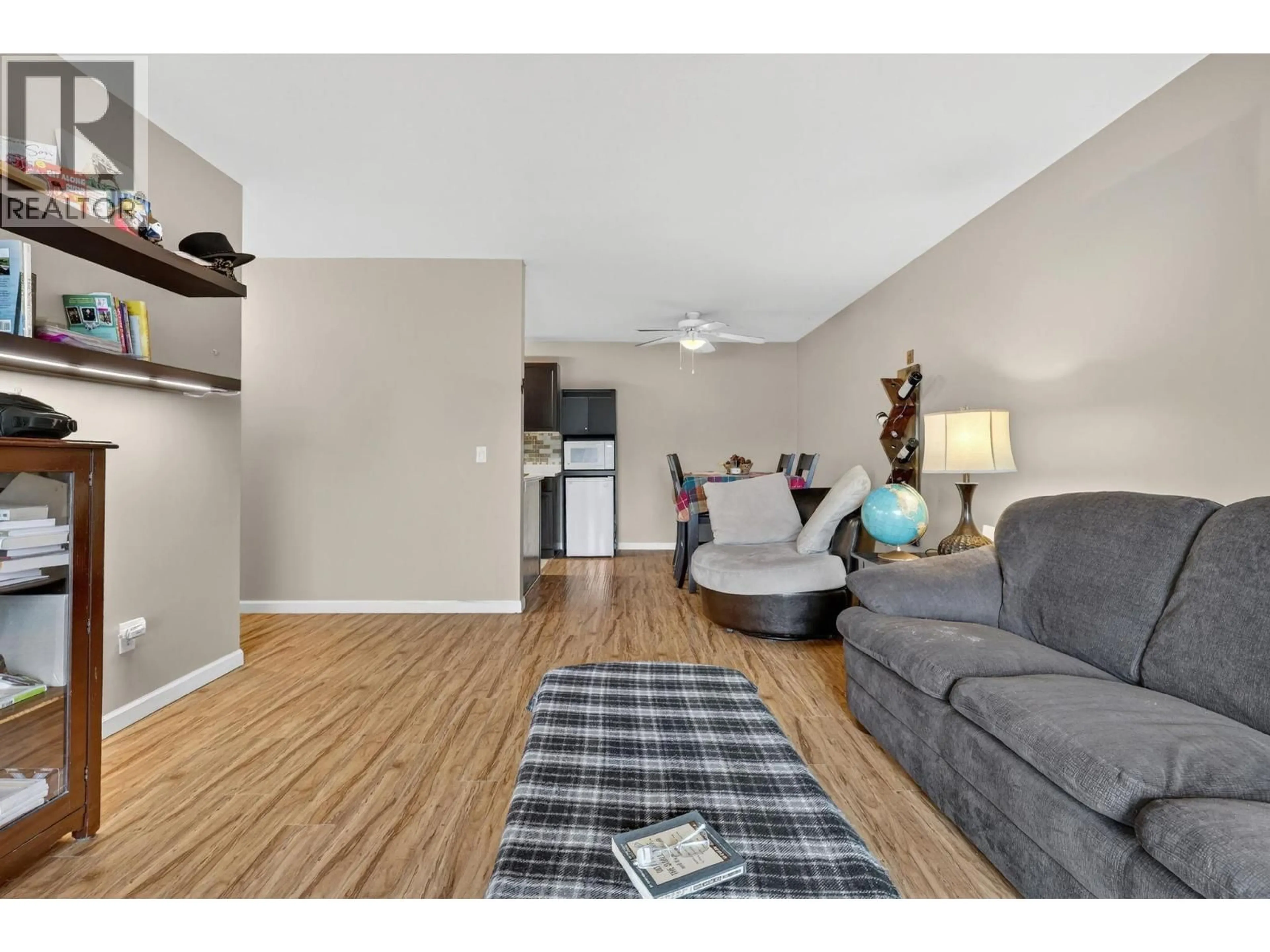 Living room with furniture, wood/laminate floor for 209 - 3160 CASORSO ROAD, Kelowna British Columbia V1W3L7