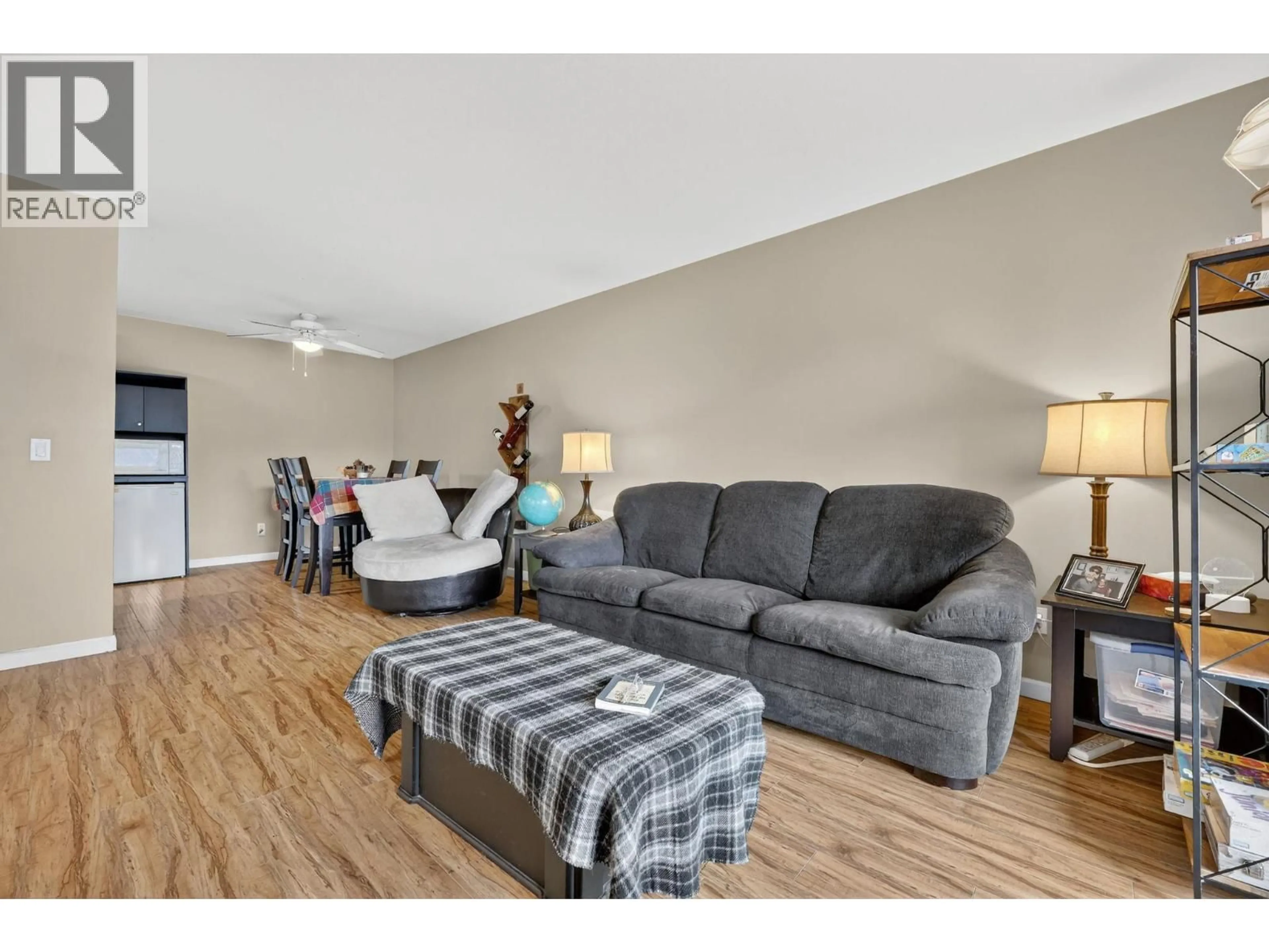 Living room with furniture, wood/laminate floor for 209 - 3160 CASORSO ROAD, Kelowna British Columbia V1W3L7