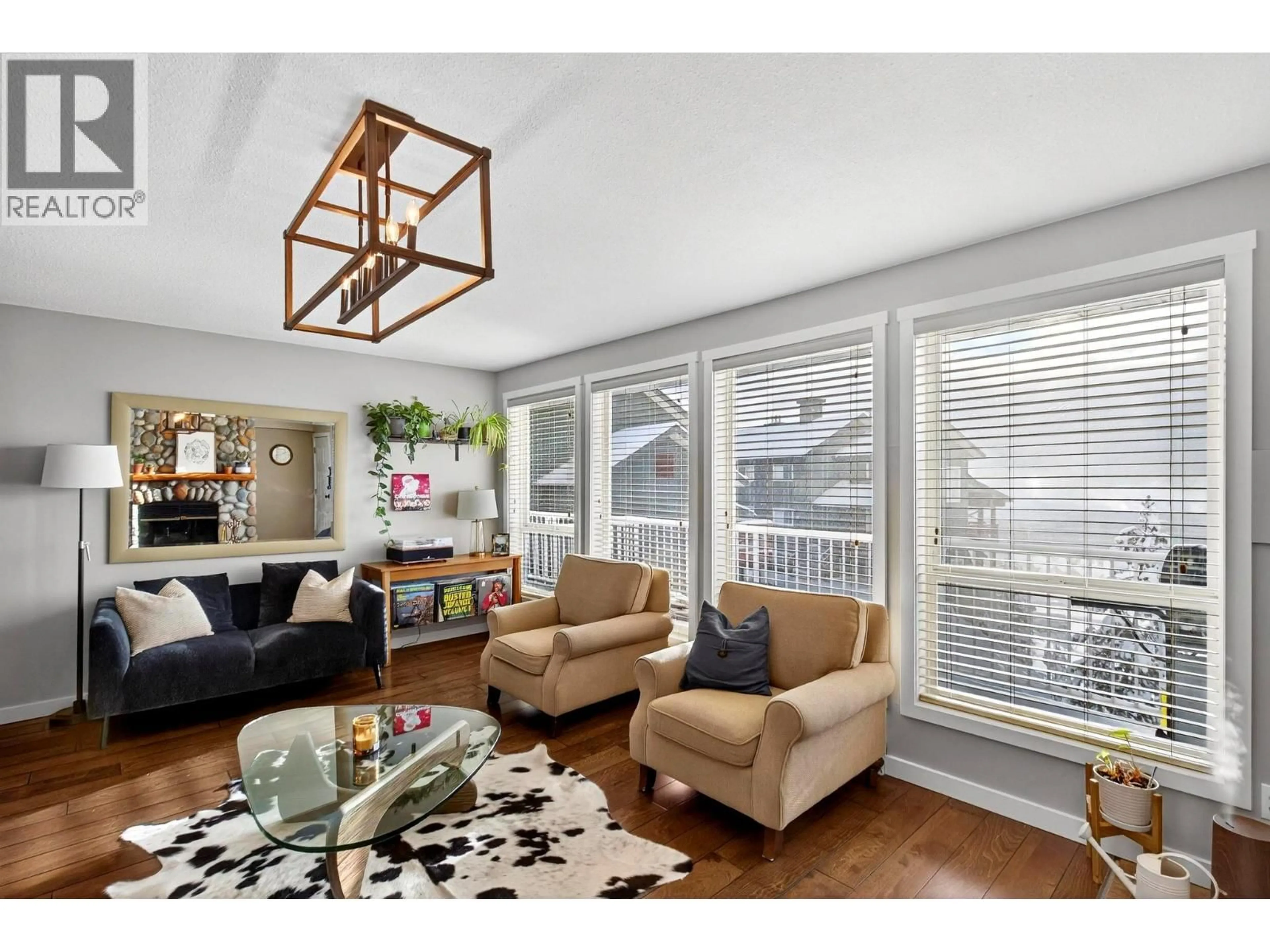 Living room with furniture, wood/laminate floor for 104 - 7375 PORCUPINE ROAD, Big White British Columbia V1P1P3