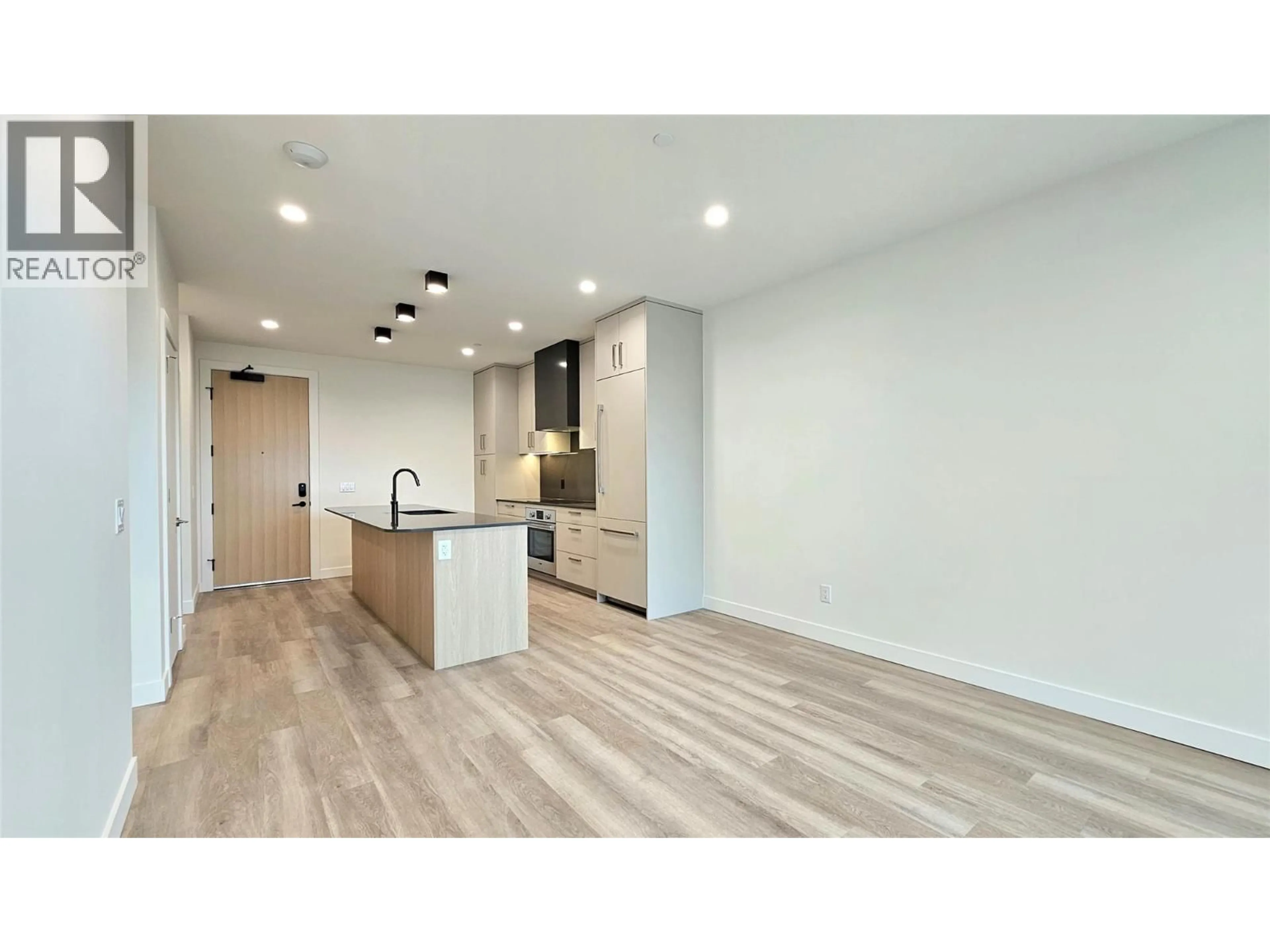 Open concept kitchen, wood/laminate floor for 606 - 3340 LAKESHORE ROAD, Kelowna British Columbia V1W0H6