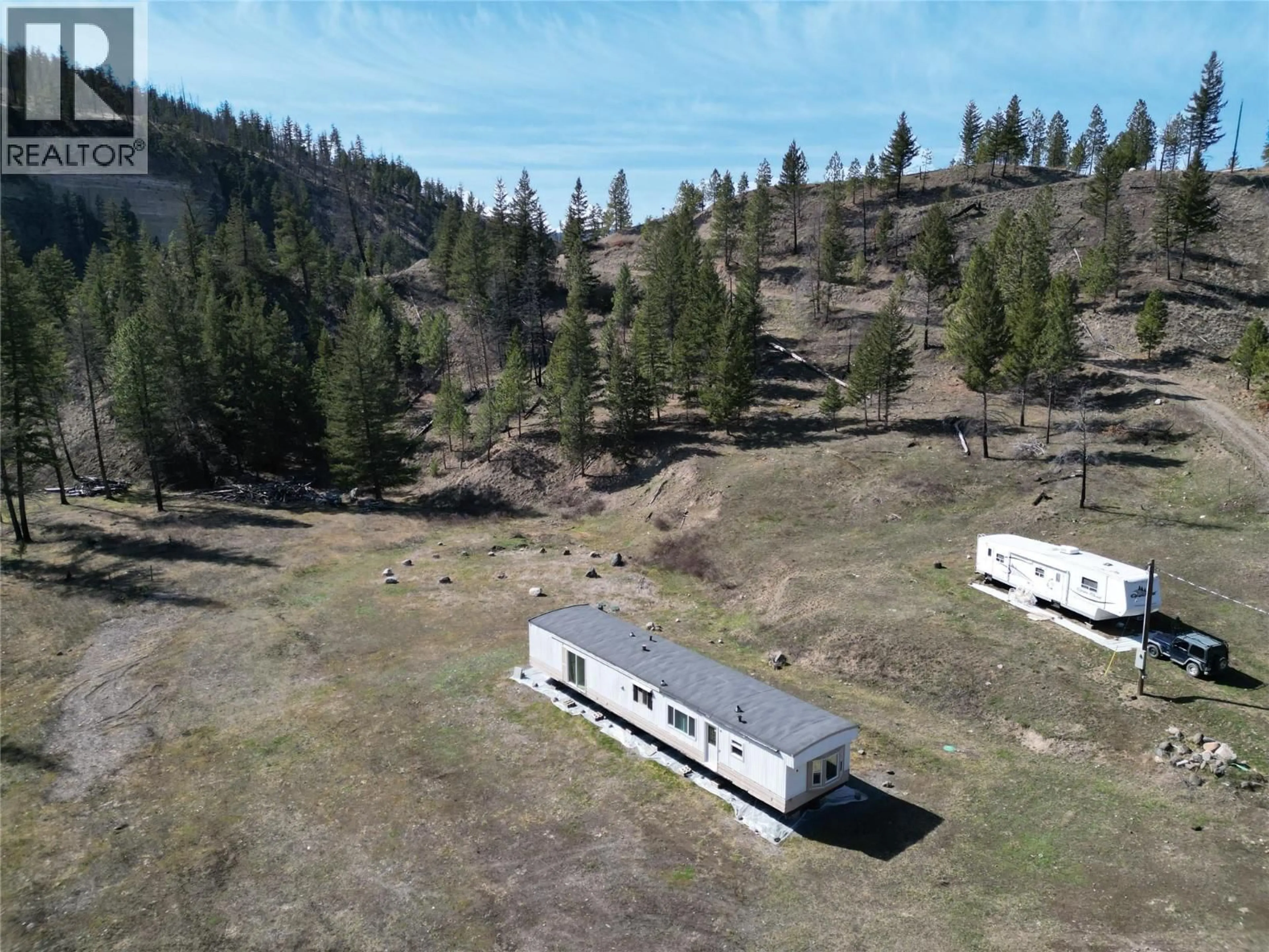 A pic from outside/outdoor area/front of a property/back of a property/a pic from drone, mountain view for 1280 RENSCH ROAD, Loon Lake British Columbia V0K1H1