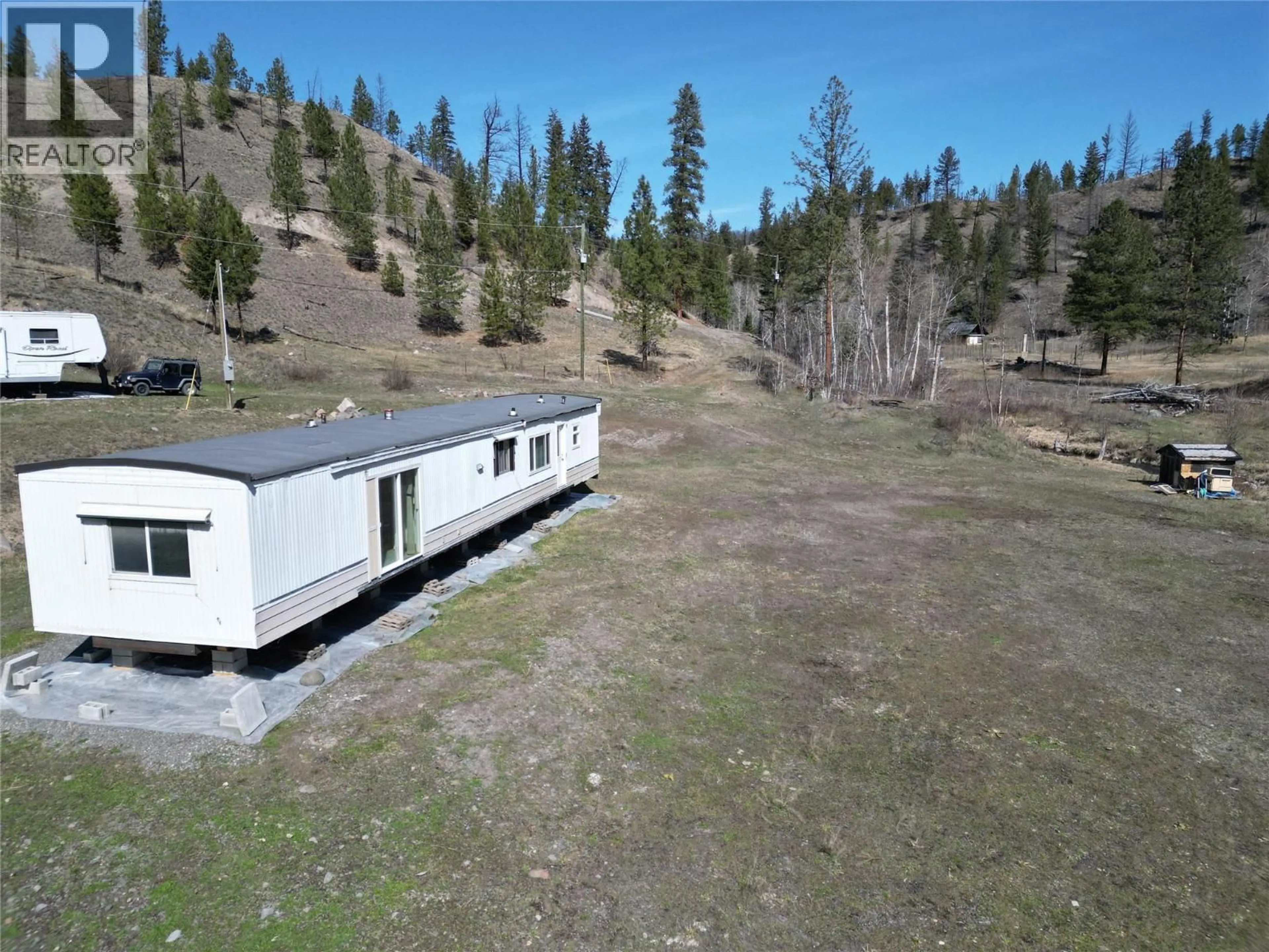 A pic from outside/outdoor area/front of a property/back of a property/a pic from drone, mountain view for 1280 RENSCH ROAD, Loon Lake British Columbia V0K1H1