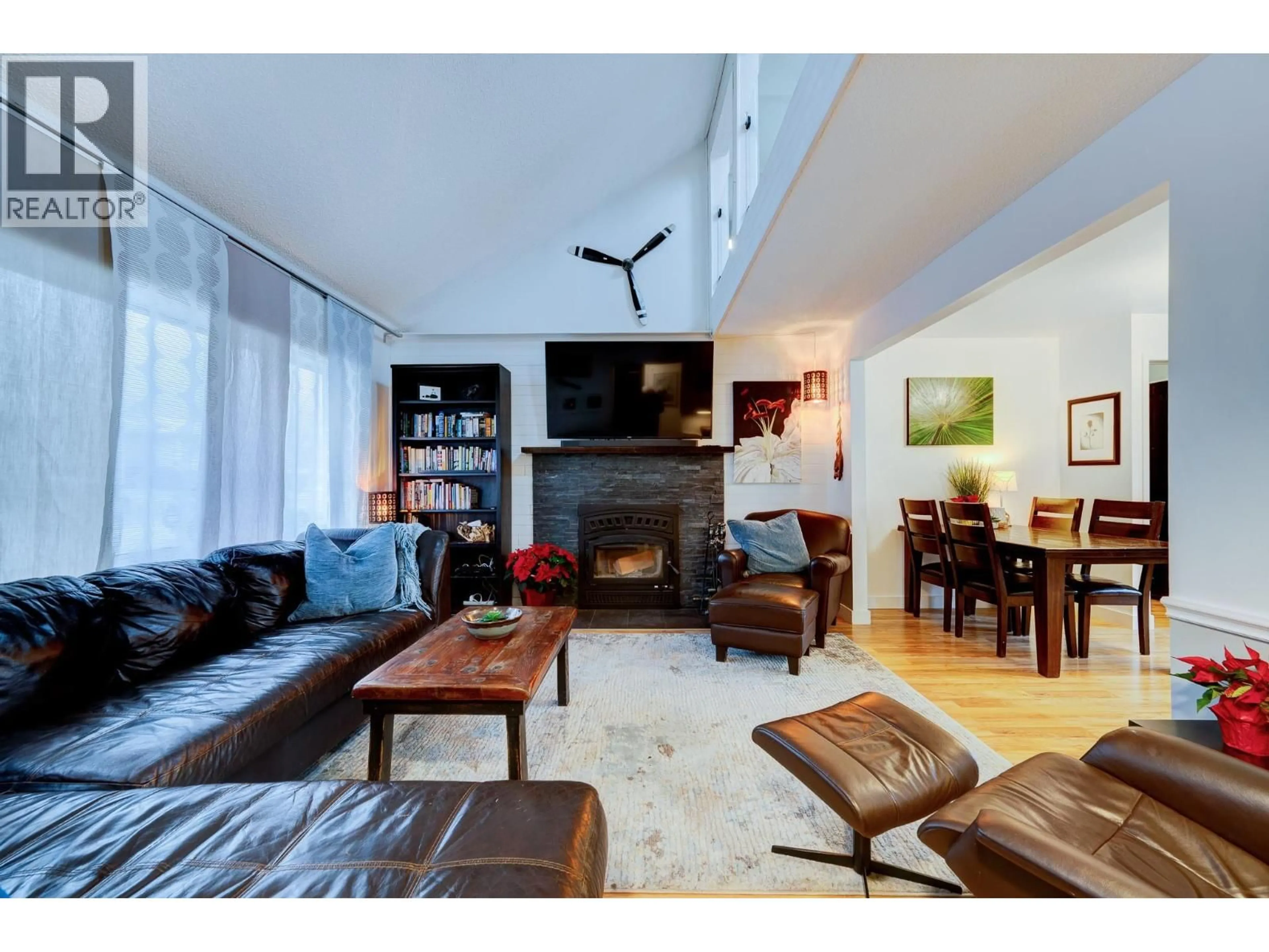 Living room with furniture, wood/laminate floor for 2426 OMINECA DRIVE, Kamloops British Columbia V2E1V6