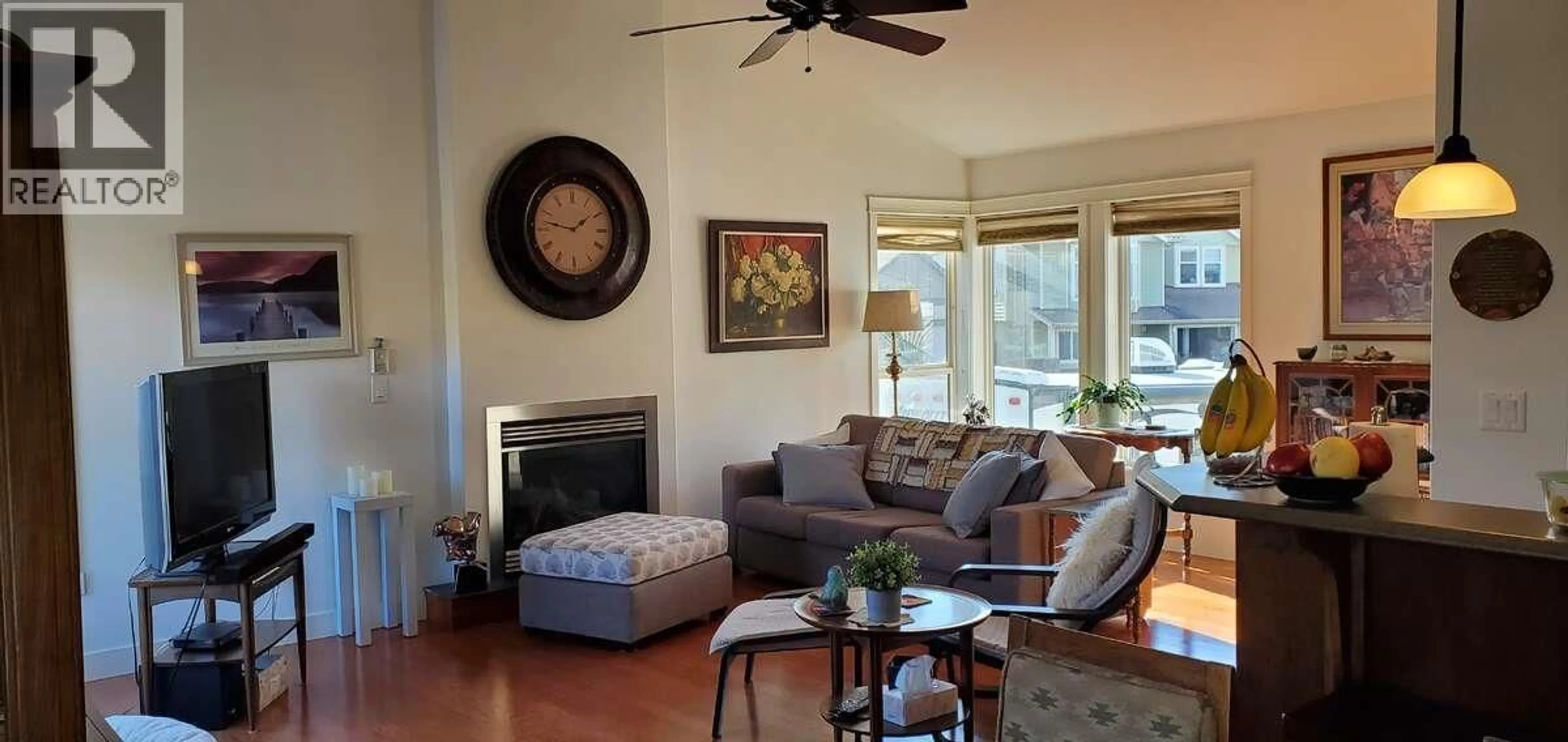 Living room with furniture, wood/laminate floor for 2150 CANTLE PLACE, Kamloops British Columbia V2B0A7