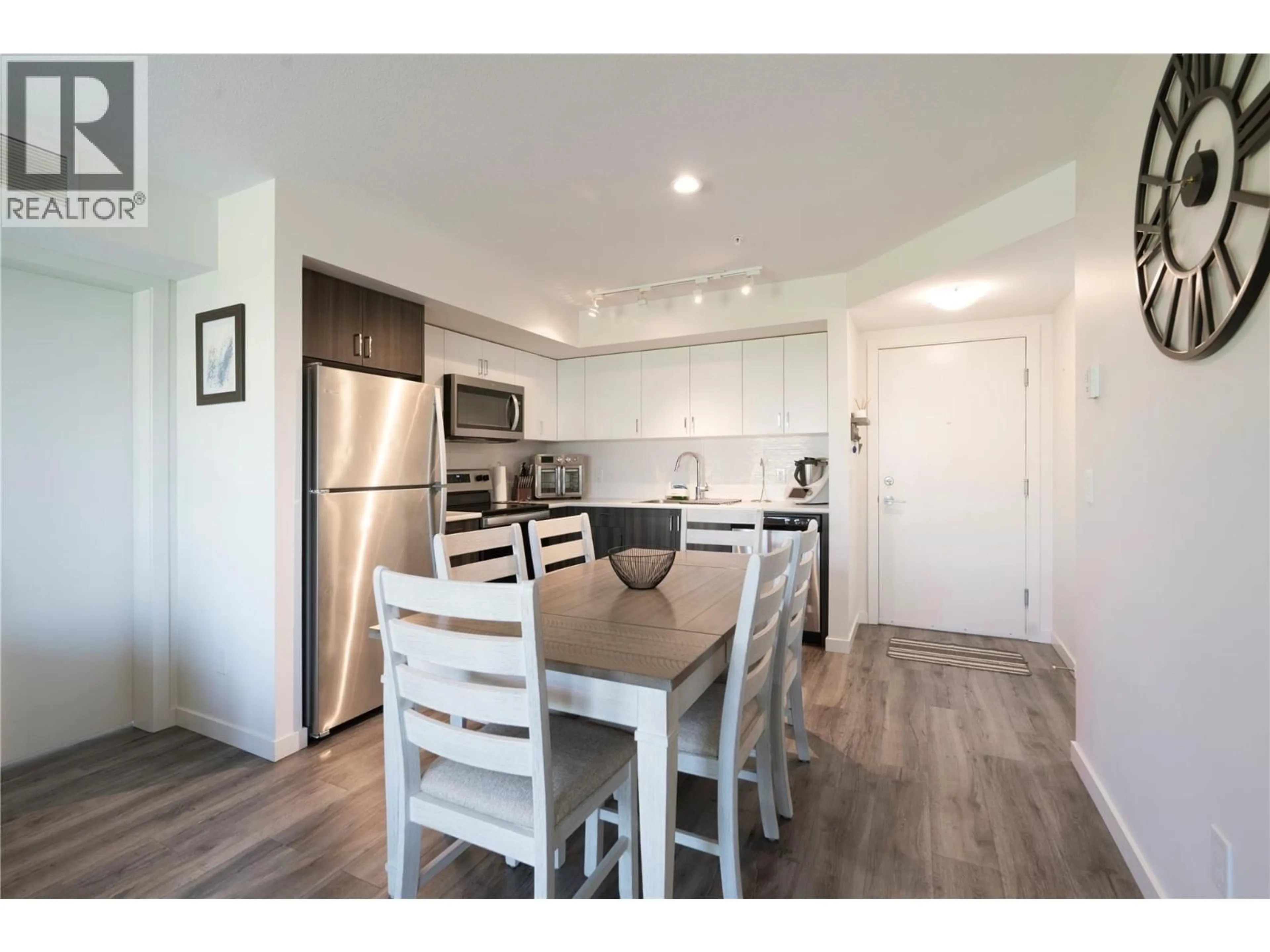 Open concept kitchen, wood/laminate floor for 210 - 625 ACADEMY WAY, Kelowna British Columbia V1V0E3