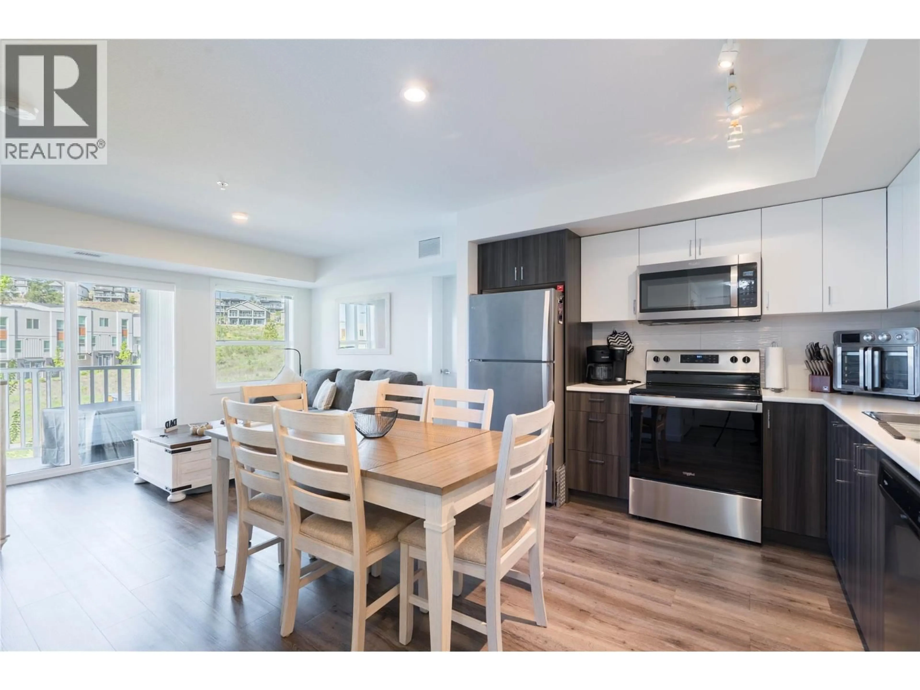 Open concept kitchen, wood/laminate floor for 210 - 625 ACADEMY WAY, Kelowna British Columbia V1V0E3