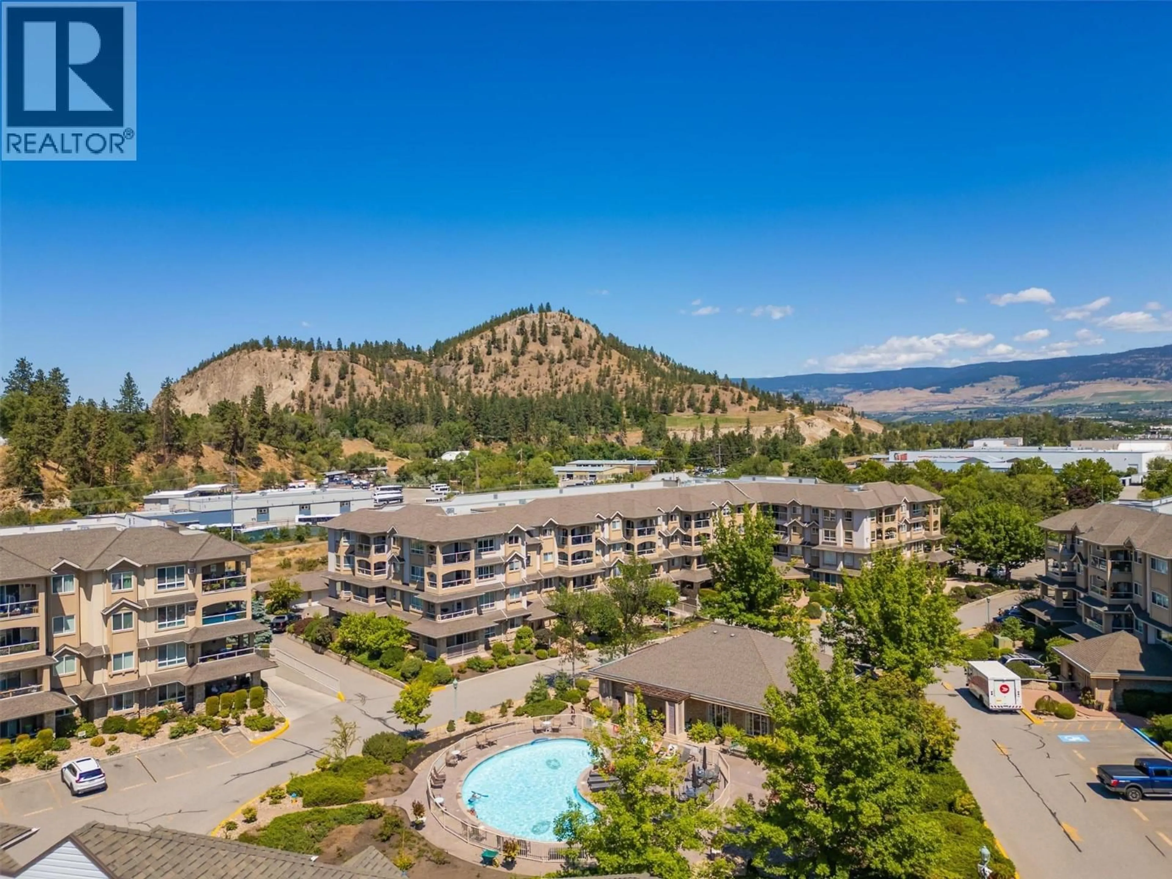 A pic from outside/outdoor area/front of a property/back of a property/a pic from drone, mountain view for 309 - 1964 ENTERPRISE WAY, Kelowna British Columbia V1Y9S7