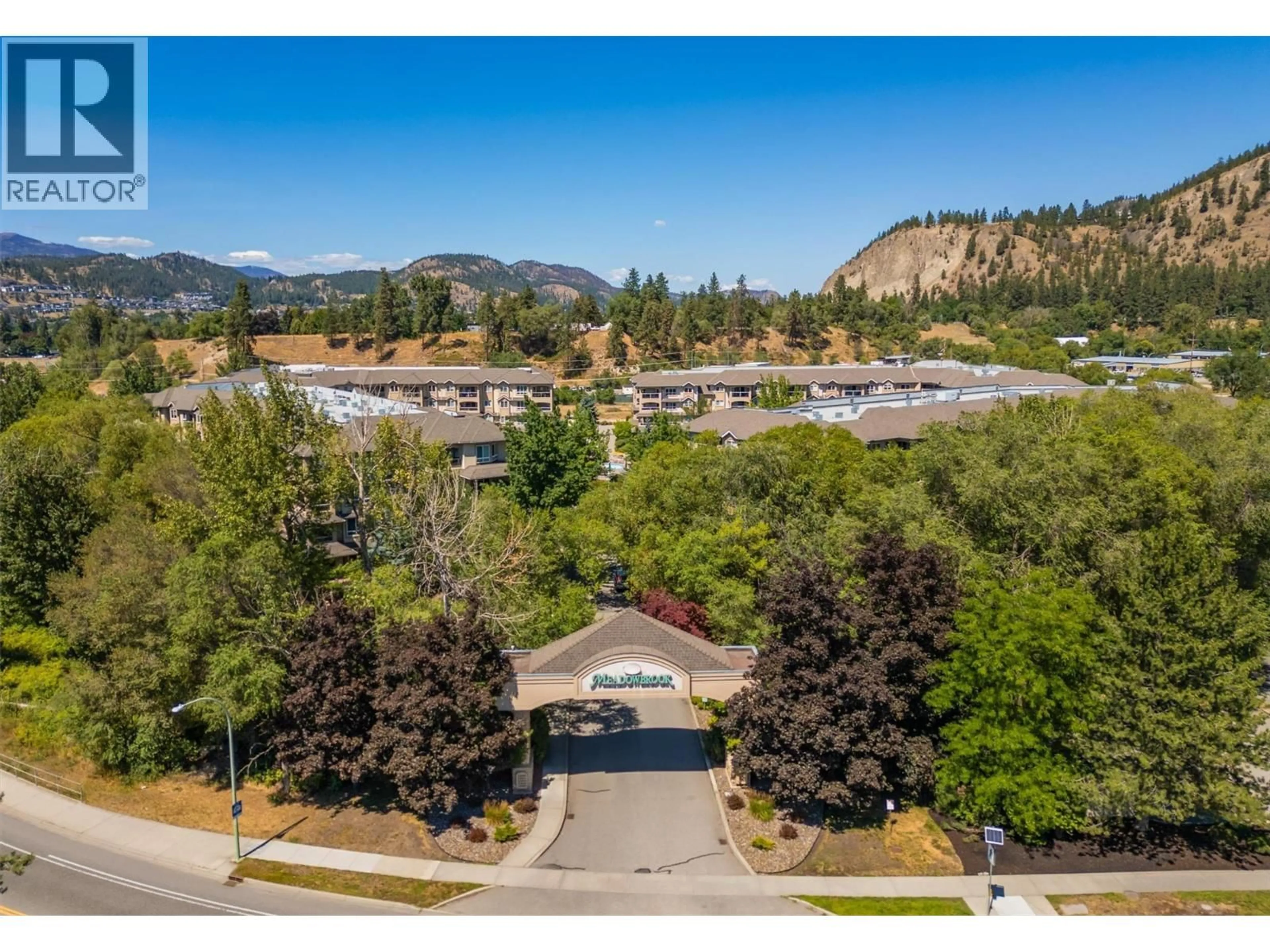A pic from outside/outdoor area/front of a property/back of a property/a pic from drone, mountain view for 309 - 1964 ENTERPRISE WAY, Kelowna British Columbia V1Y9S7