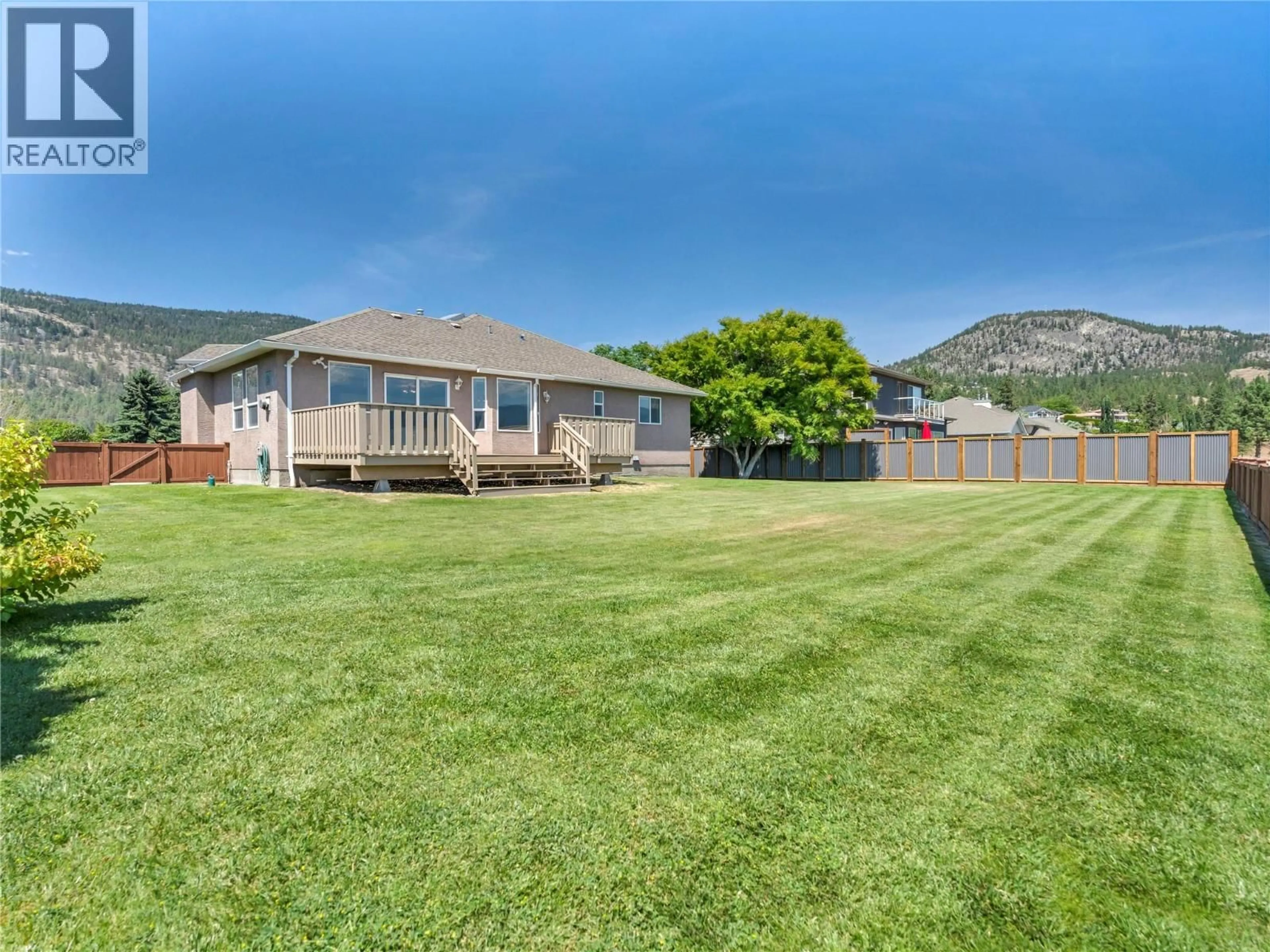 A pic from outside/outdoor area/front of a property/back of a property/a pic from drone, mountain view for 1893 SANDSTONE DRIVE, Penticton British Columbia V2A8Y6