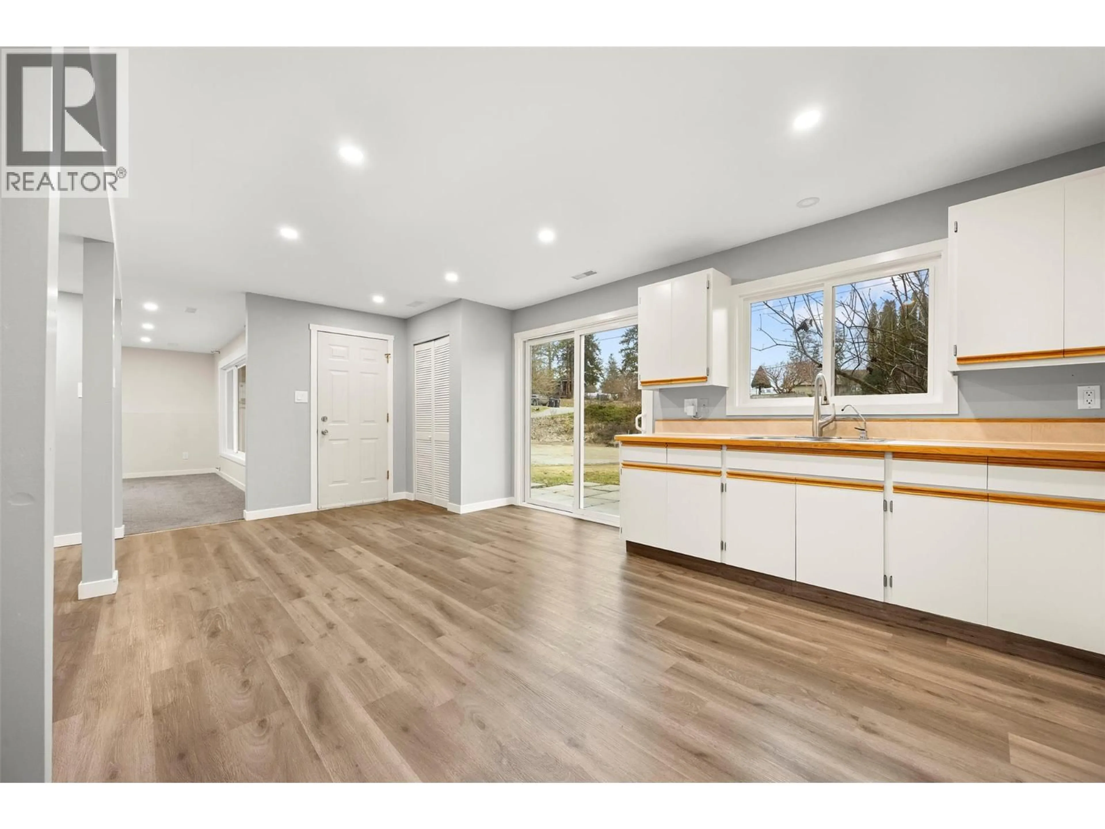Open concept kitchen, wood/laminate floor for 6348 FOREST HILL DRIVE, Peachland British Columbia V0H1X8
