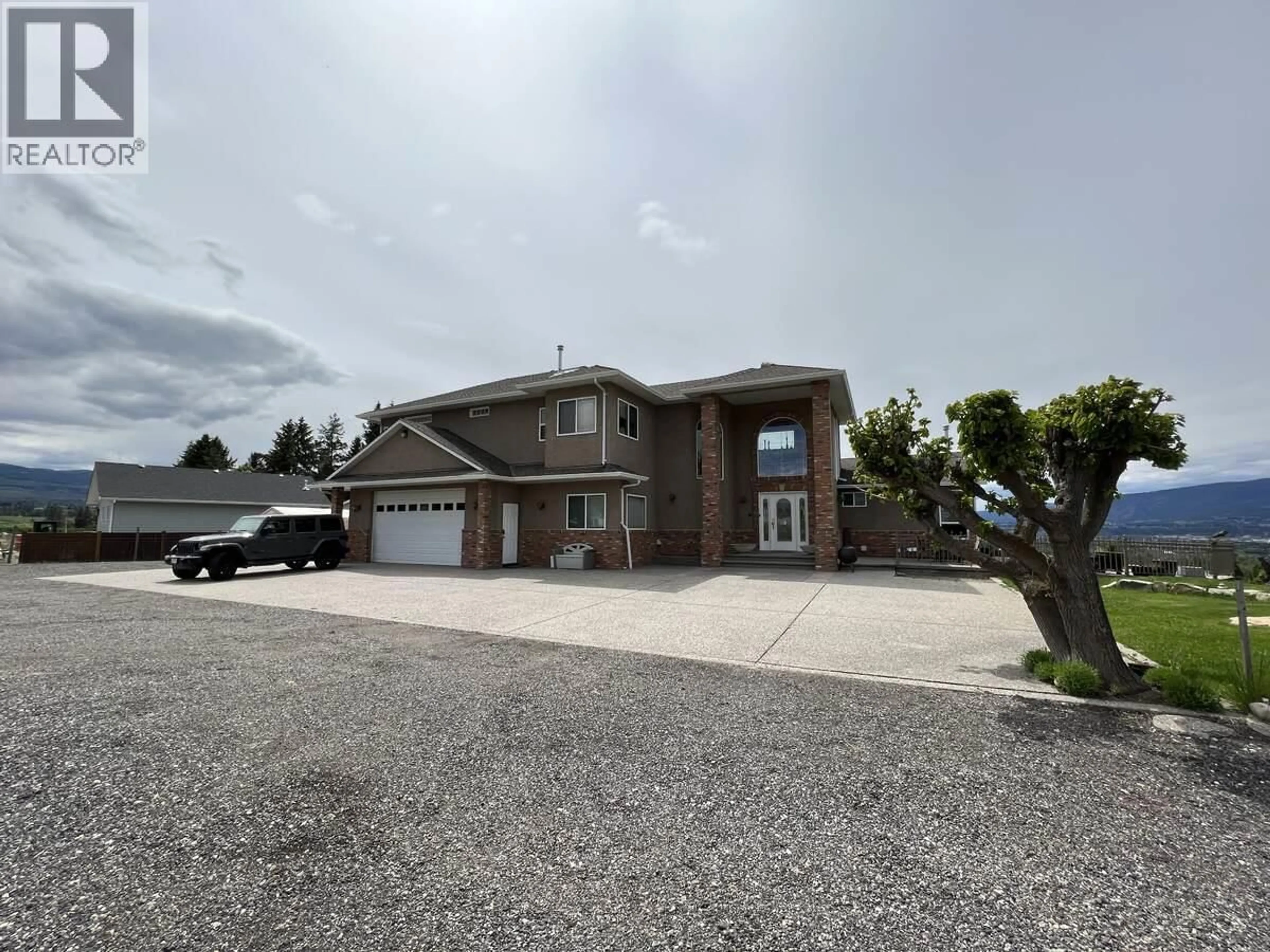 A pic from outside/outdoor area/front of a property/back of a property/a pic from drone, street for 3380 NEID ROAD, Kelowna British Columbia V1W4H5