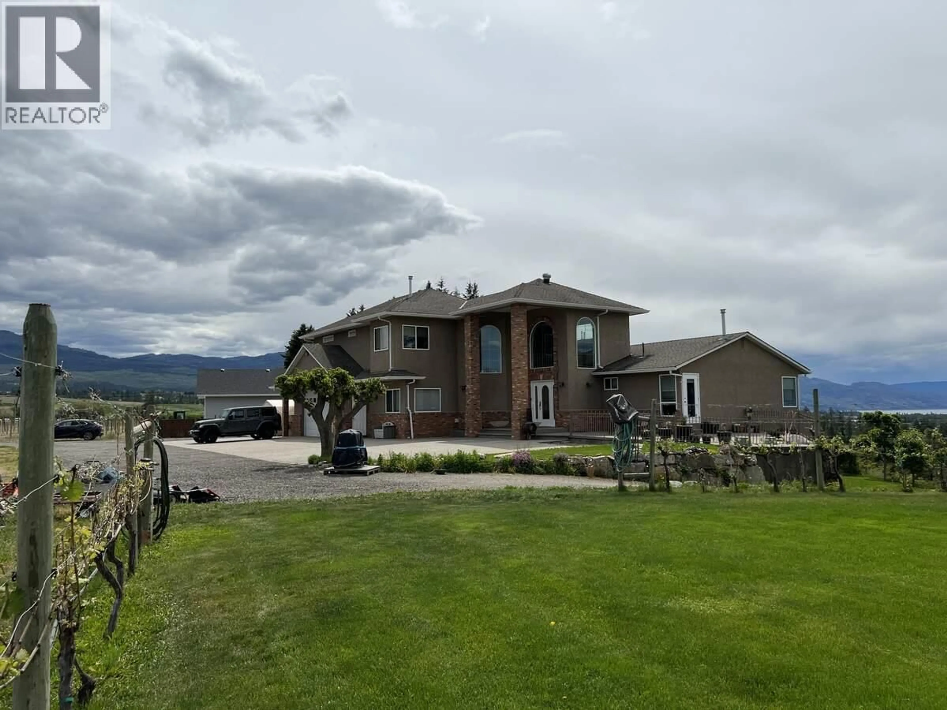 A pic from outside/outdoor area/front of a property/back of a property/a pic from drone, mountain view for 3380 NEID ROAD, Kelowna British Columbia V1W4H5