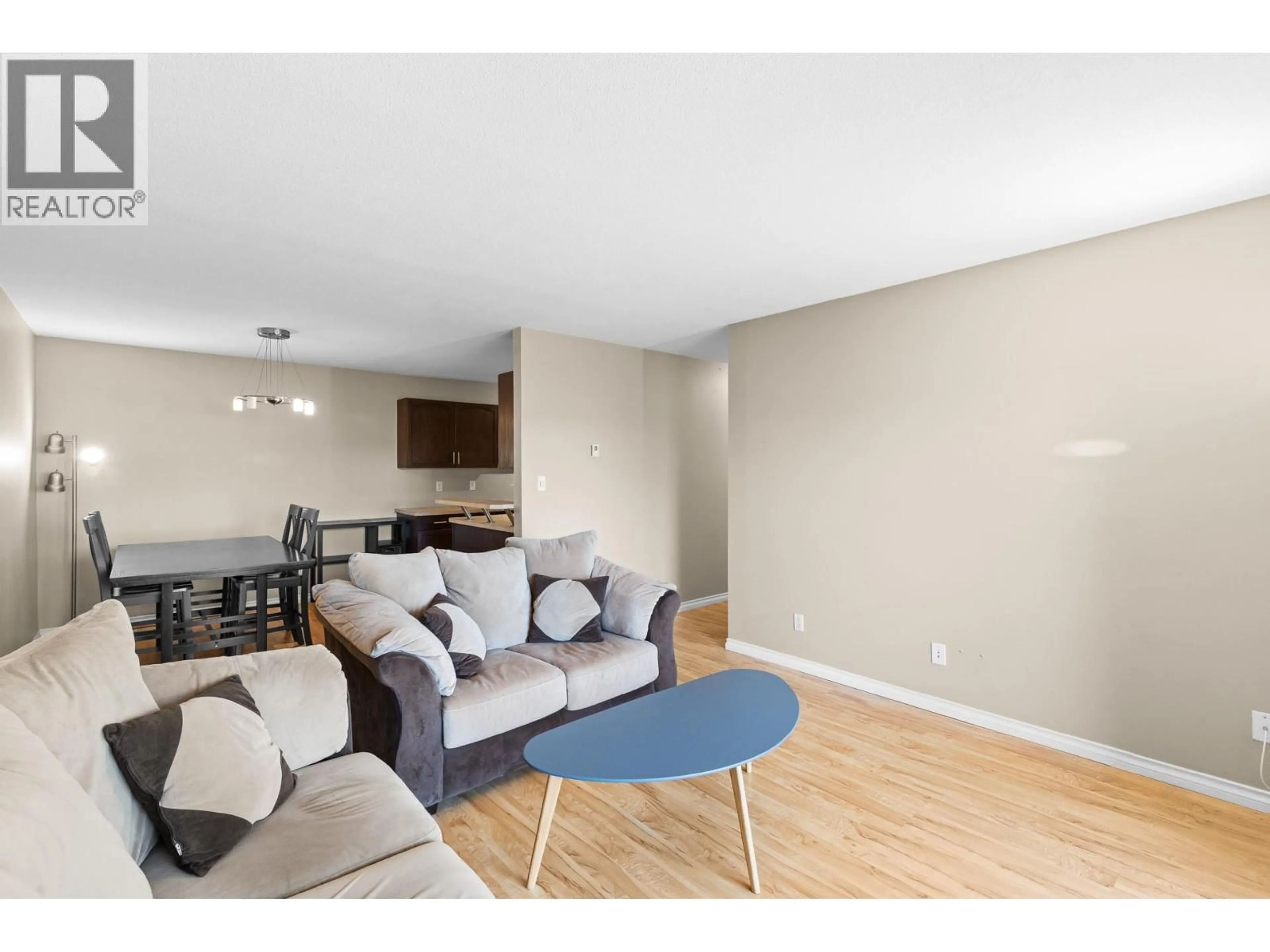 Living room with furniture, wood/laminate floor for 308 - 3163 RICHTER STREET, Kelowna British Columbia V1W3R4