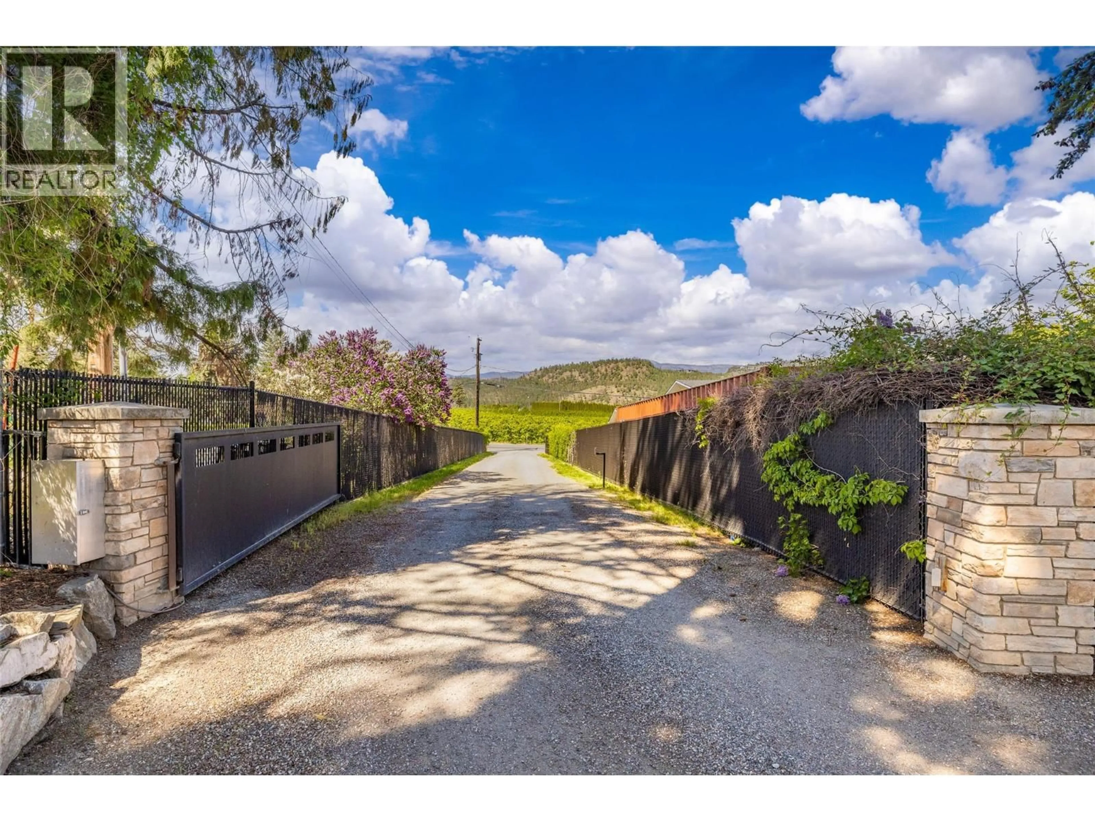 A pic from outside/outdoor area/front of a property/back of a property/a pic from drone, street for 2430 LONGHILL ROAD, Kelowna British Columbia V1V2G3