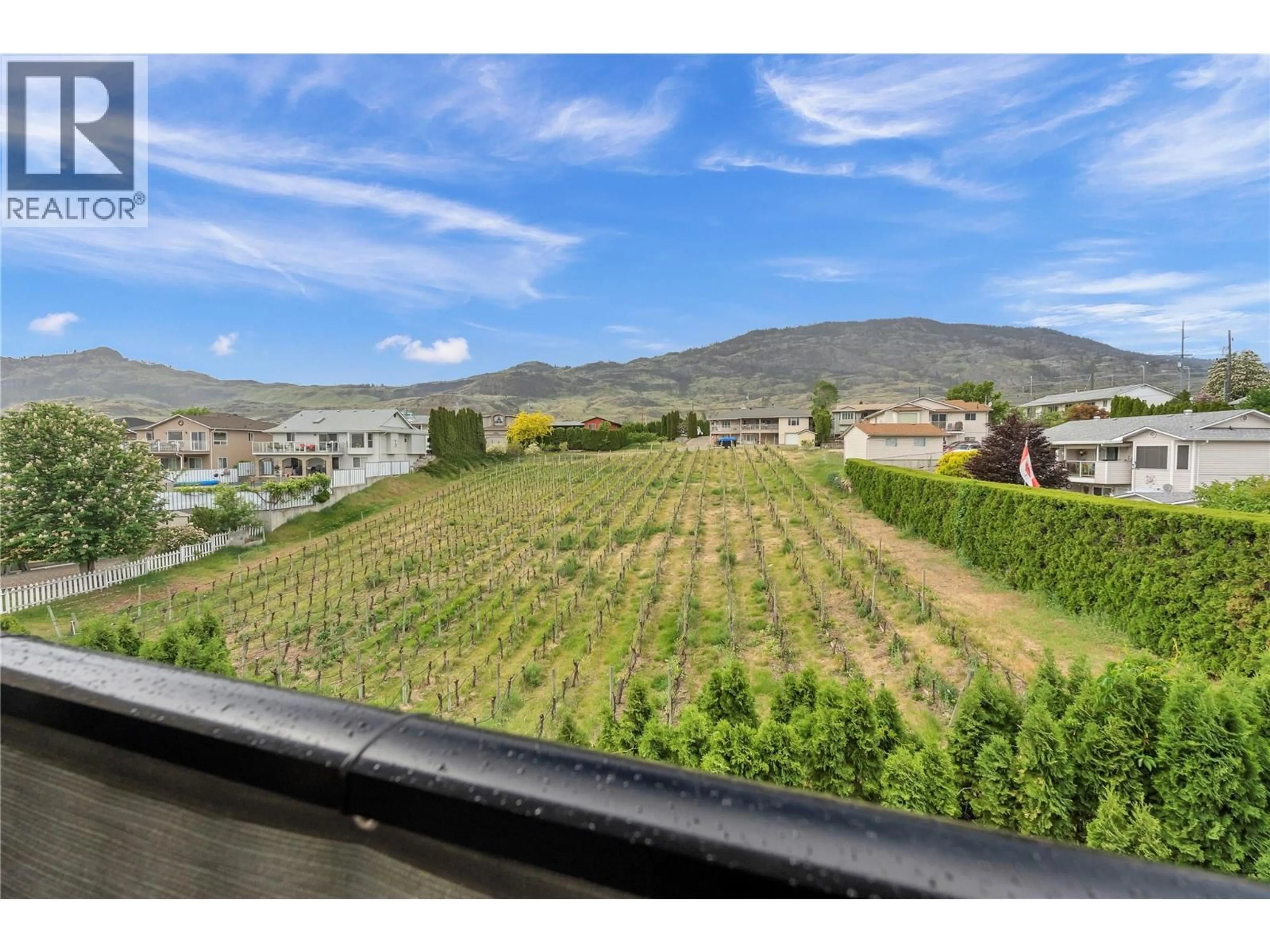 A pic from outside/outdoor area/front of a property/back of a property/a pic from drone, mountain view for 309 - 9307 62 AVENUE, Osoyoos British Columbia V0H1V4