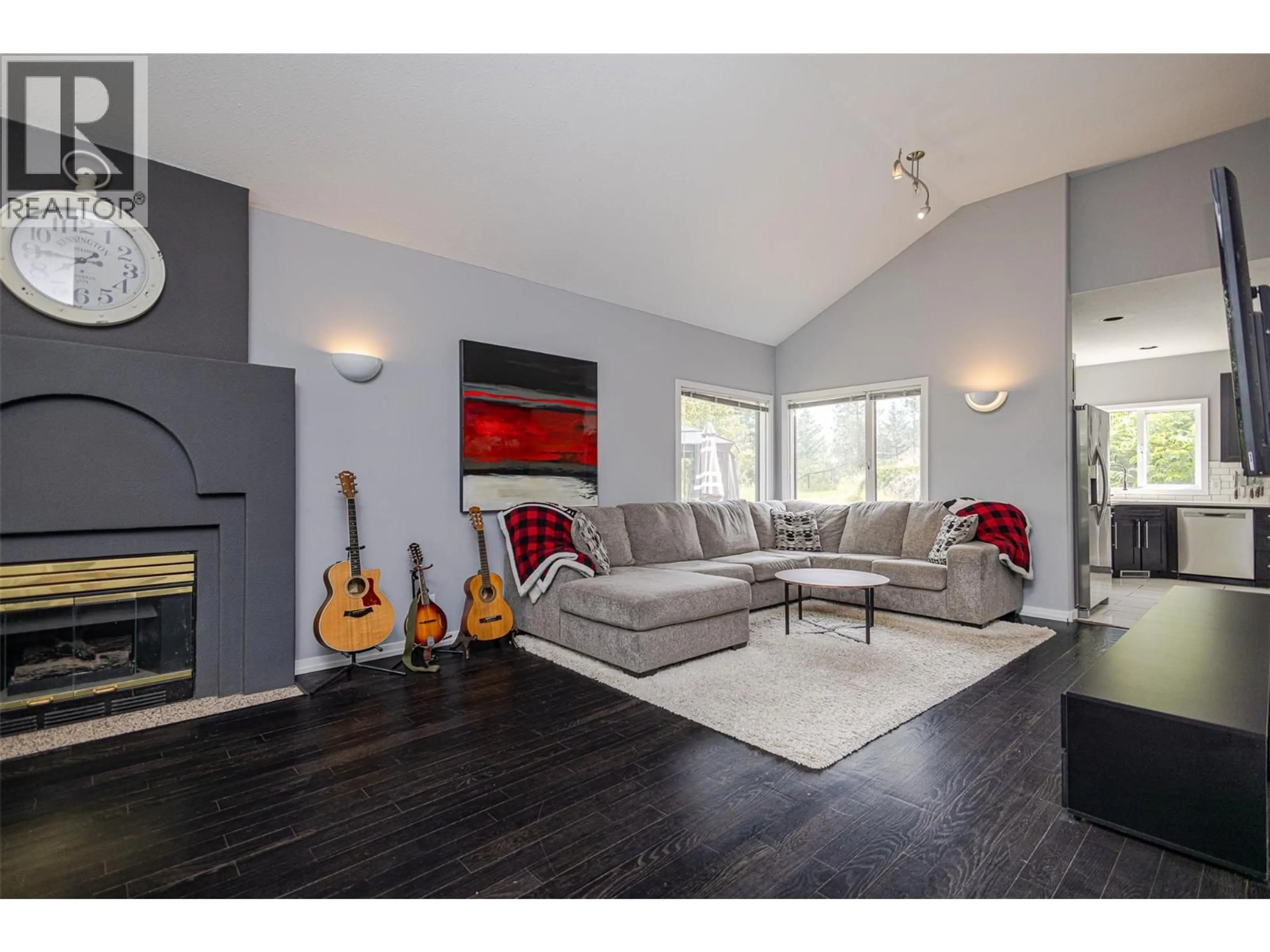 Living room with furniture, wood/laminate floor for 1791 SPRUCEGROVE COURT, Kelowna British Columbia V1V1P3