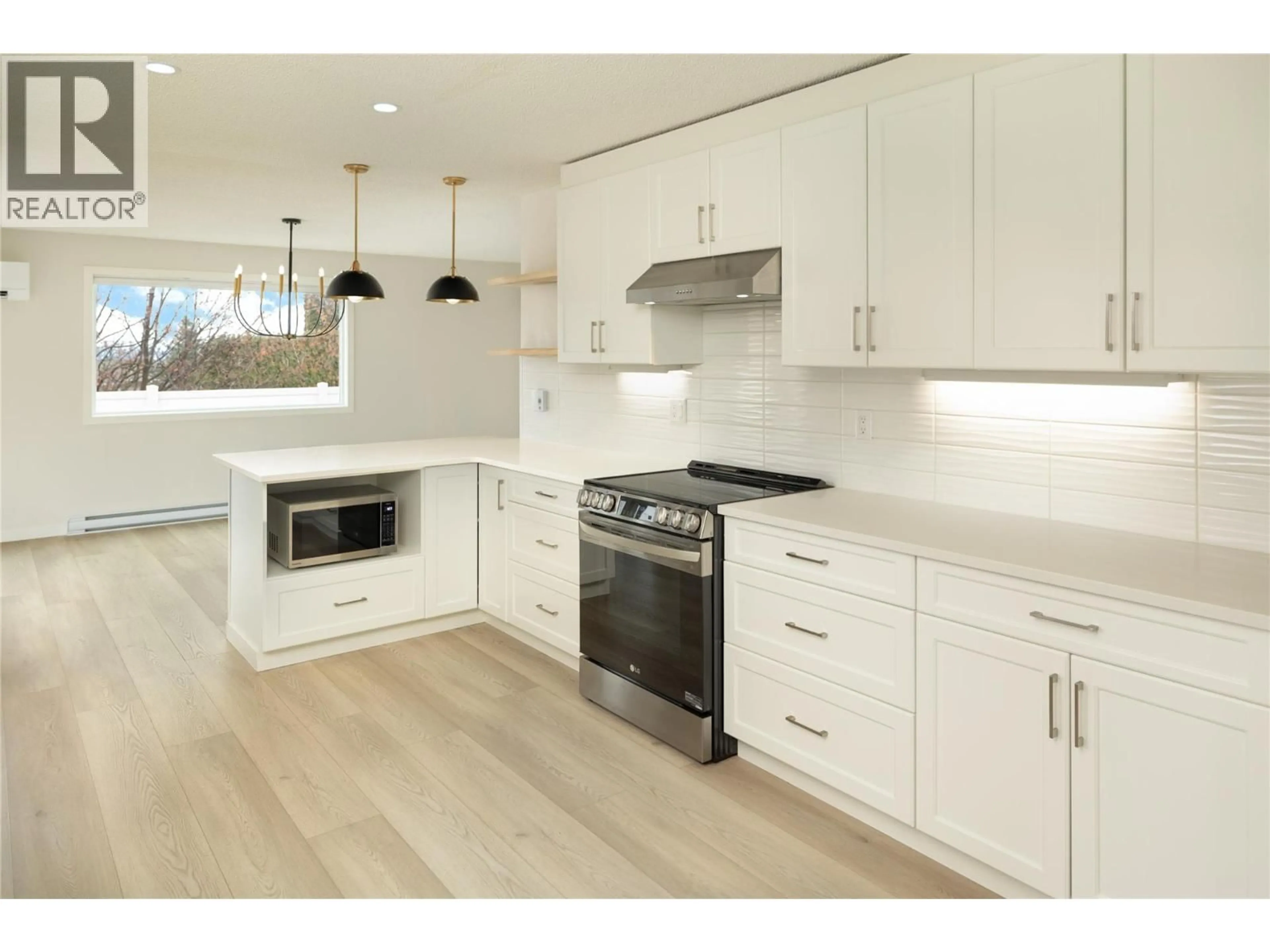 Open concept kitchen, wood/laminate floor for 4790 SEATON PLACE, Peachland British Columbia V0H1X4