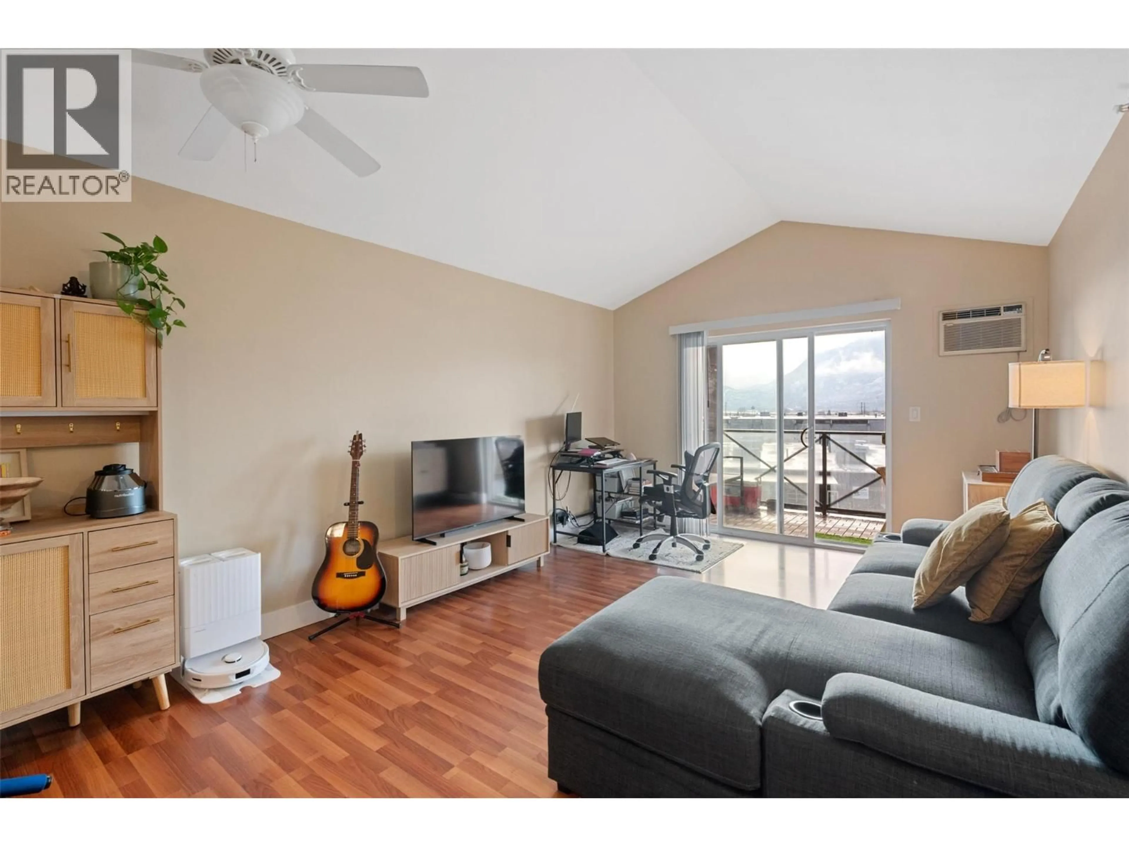 Living room with furniture, wood/laminate floor for 406 - 256 HASTINGS AVENUE, Penticton British Columbia V2A2V6