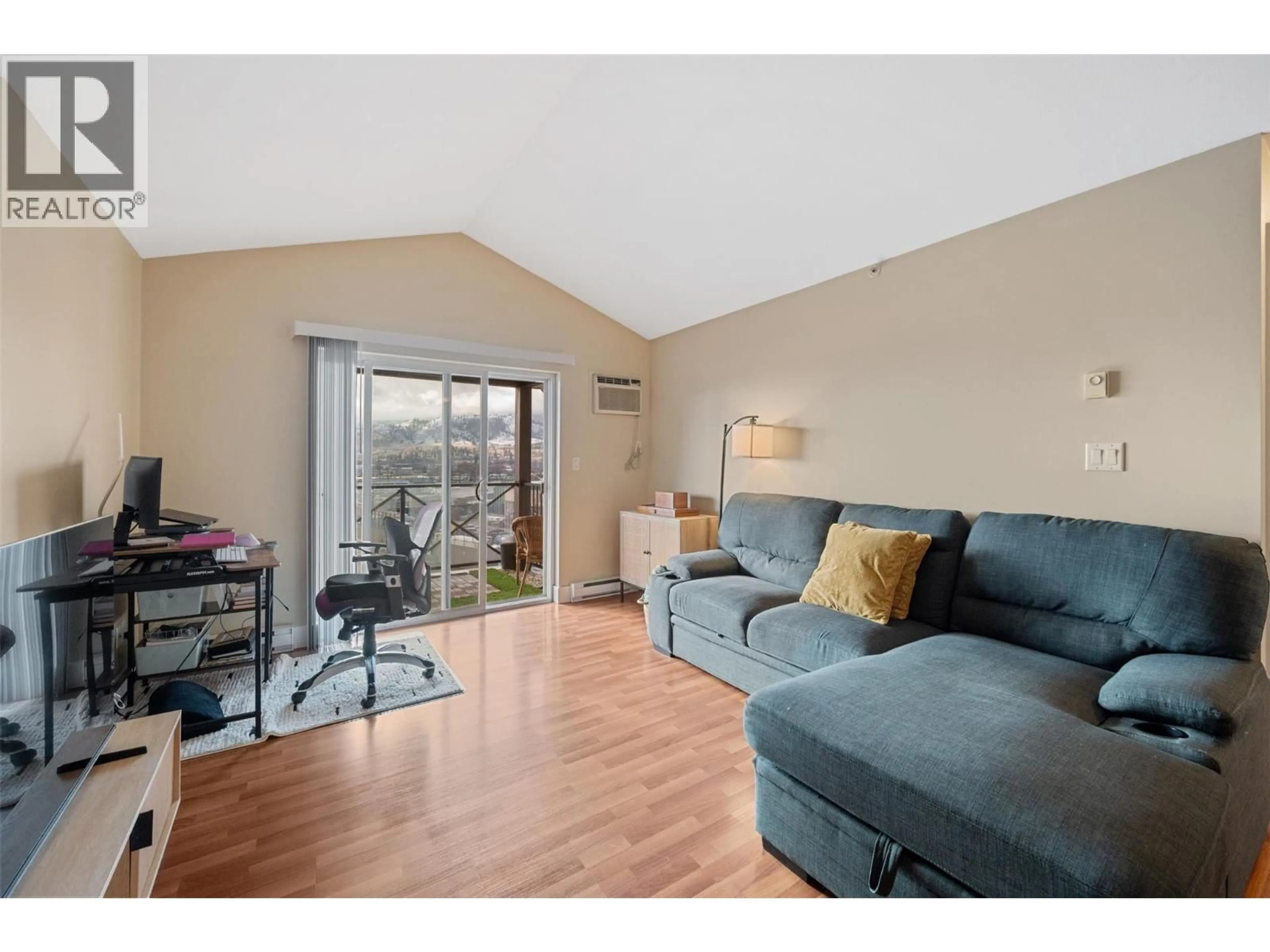 Living room with furniture, wood/laminate floor for 406 - 256 HASTINGS AVENUE, Penticton British Columbia V2A2V6