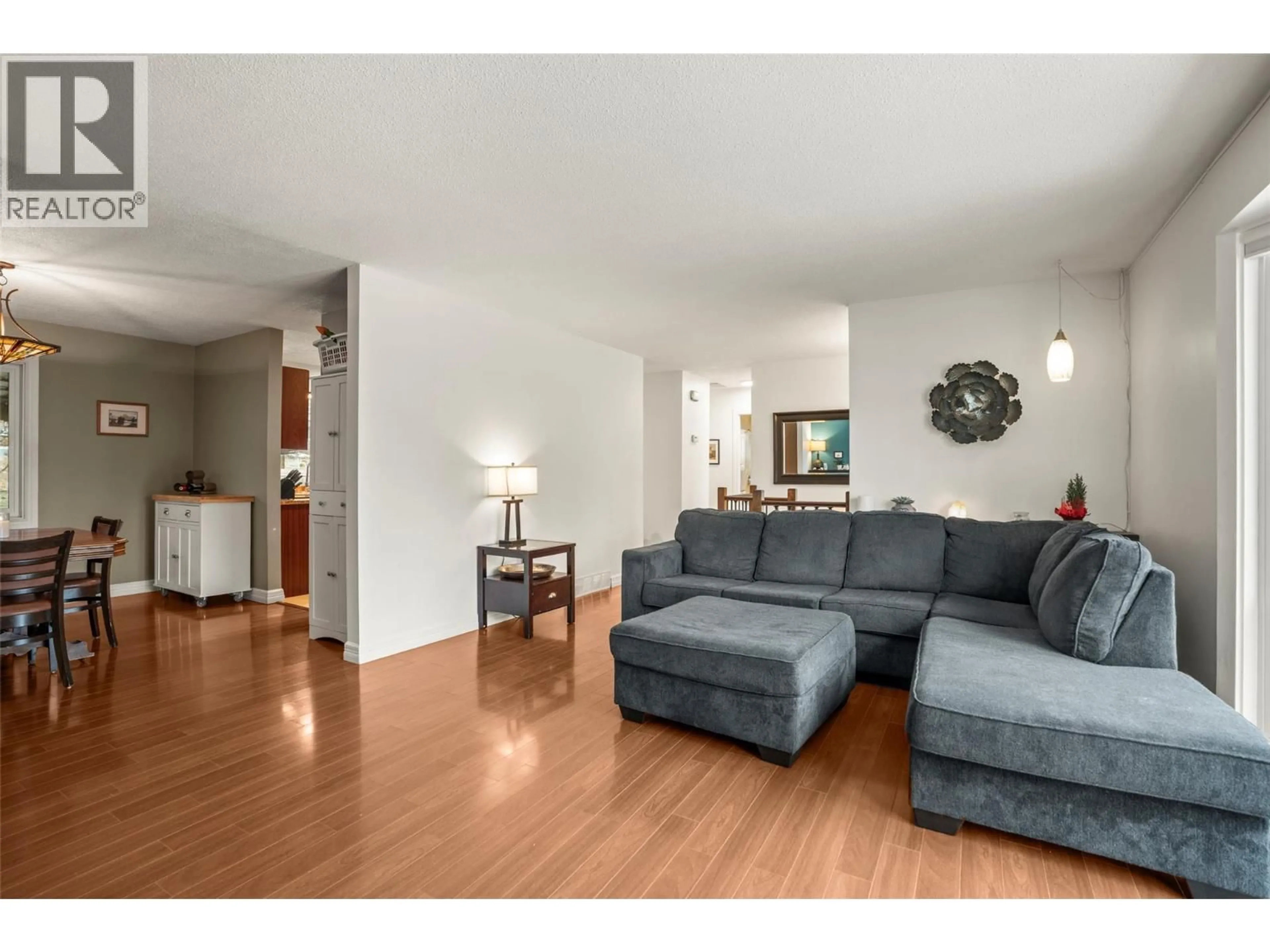 Living room with furniture, wood/laminate floor for 2102 41 AVENUE, Vernon British Columbia V1T3G8