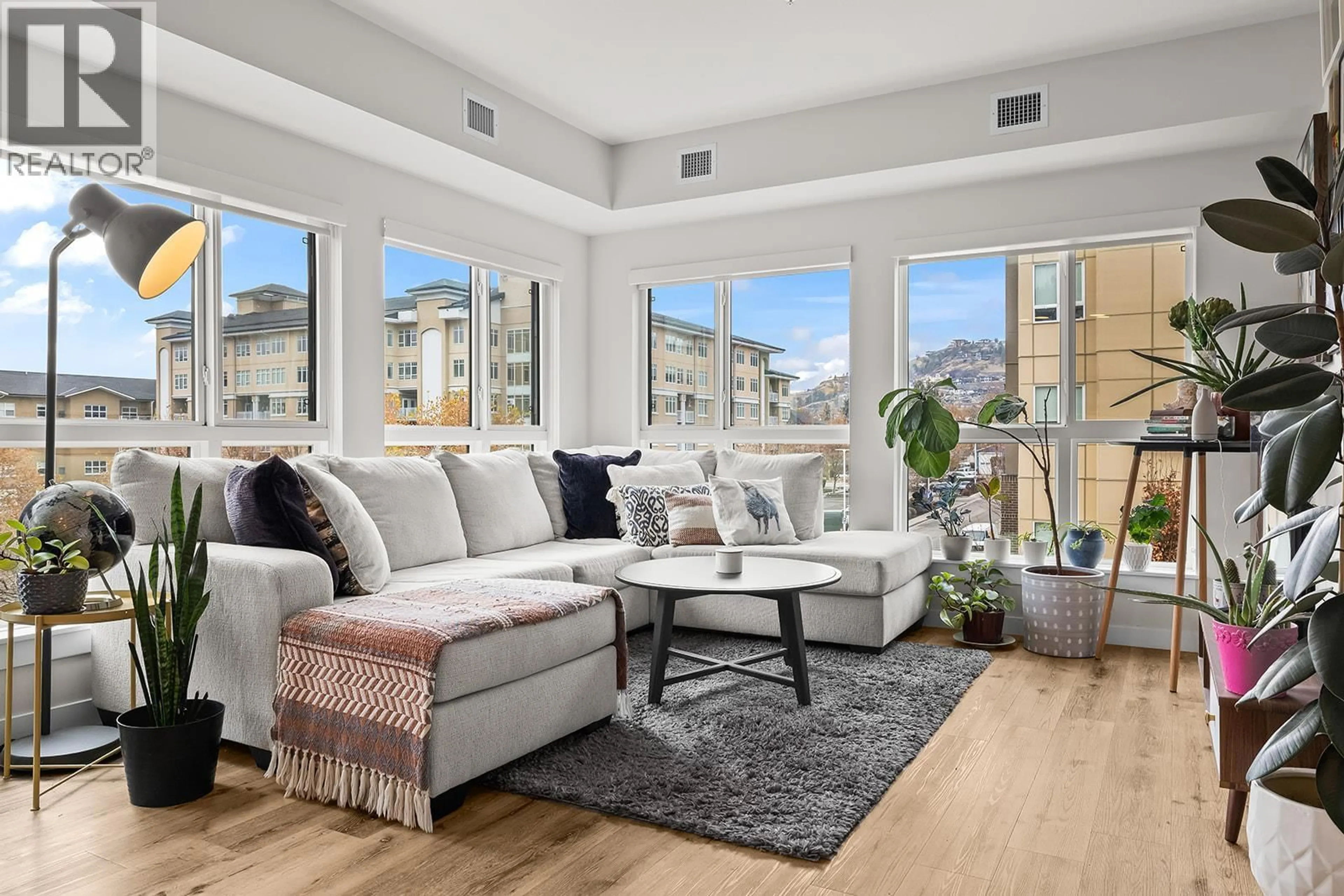 Living room with furniture, wood/laminate floor for 312 - 722 VALLEY ROAD, Kelowna British Columbia V1V2E6