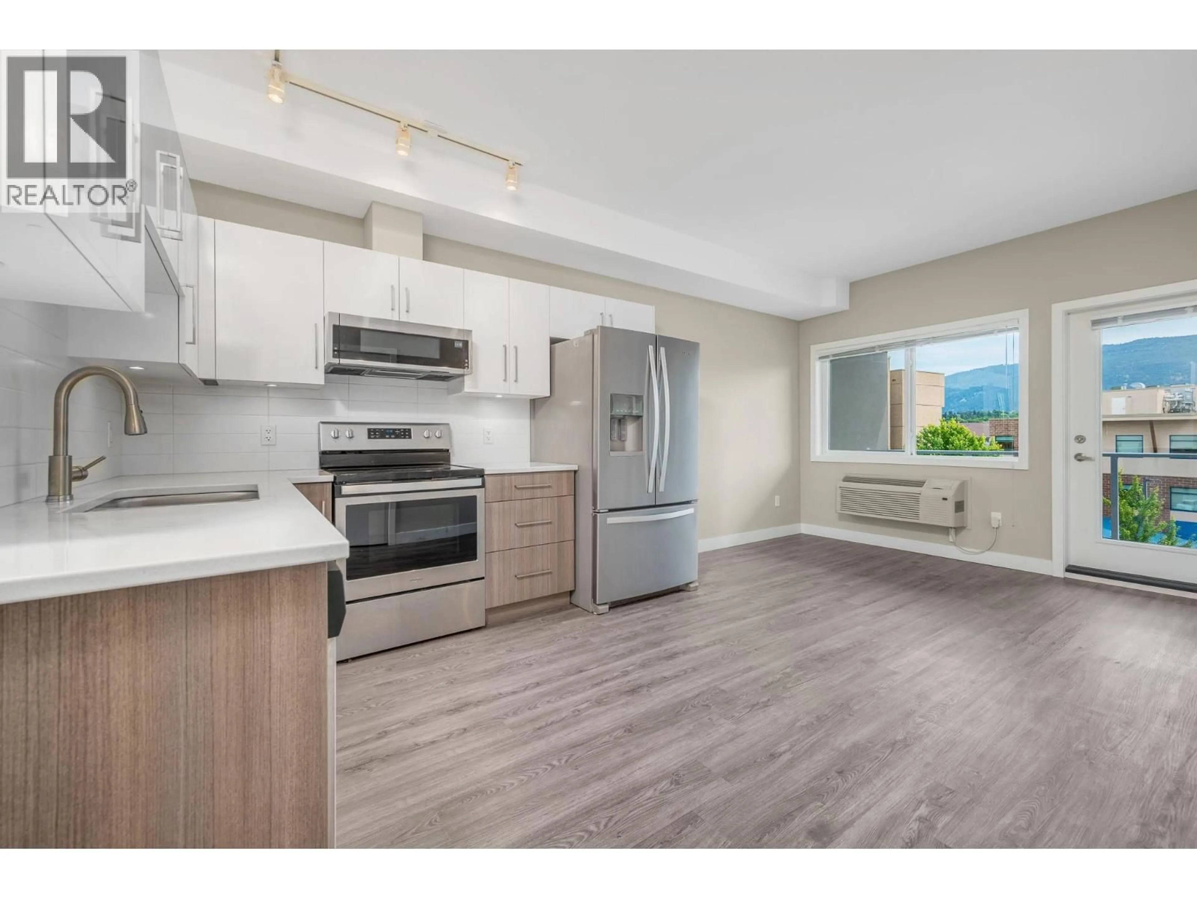 Open concept kitchen, wood/laminate floor for 413 - 3409 28 AVENUE, Vernon British Columbia V1T0B3