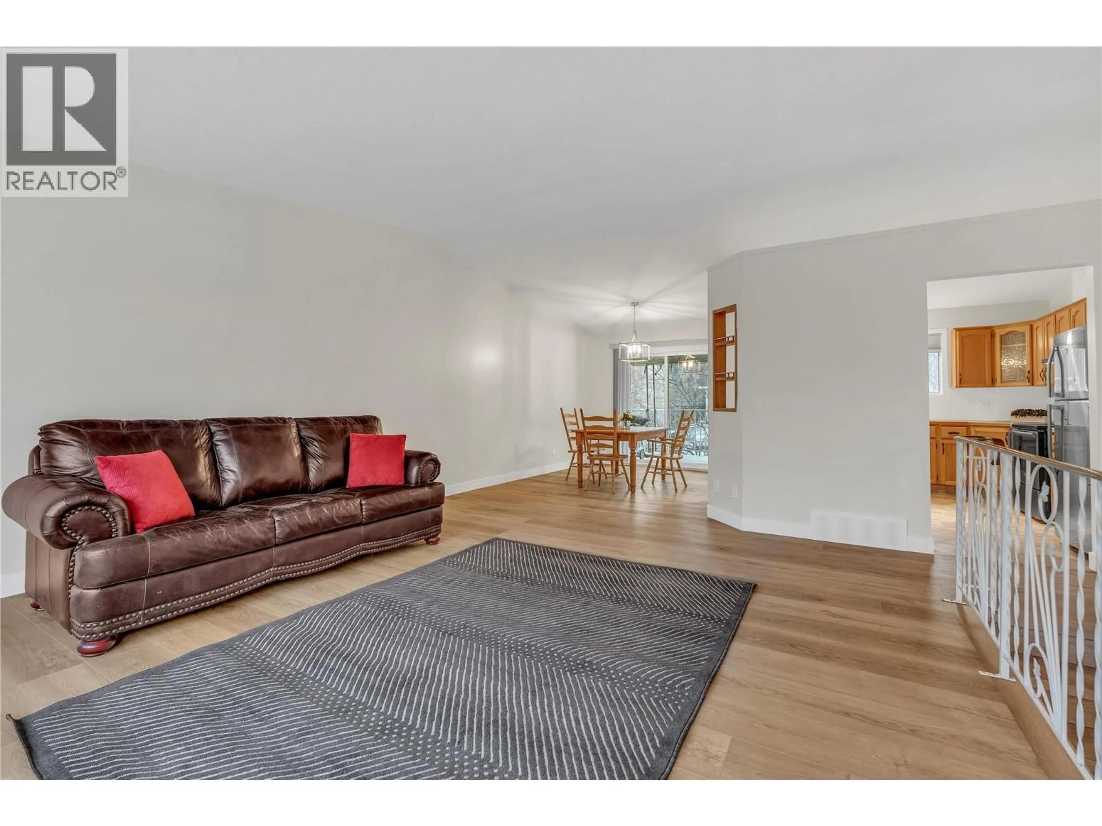 Living room with furniture, wood/laminate floor for 7111 PEACH ORCHARD ROAD, Summerland British Columbia V0H1Z6