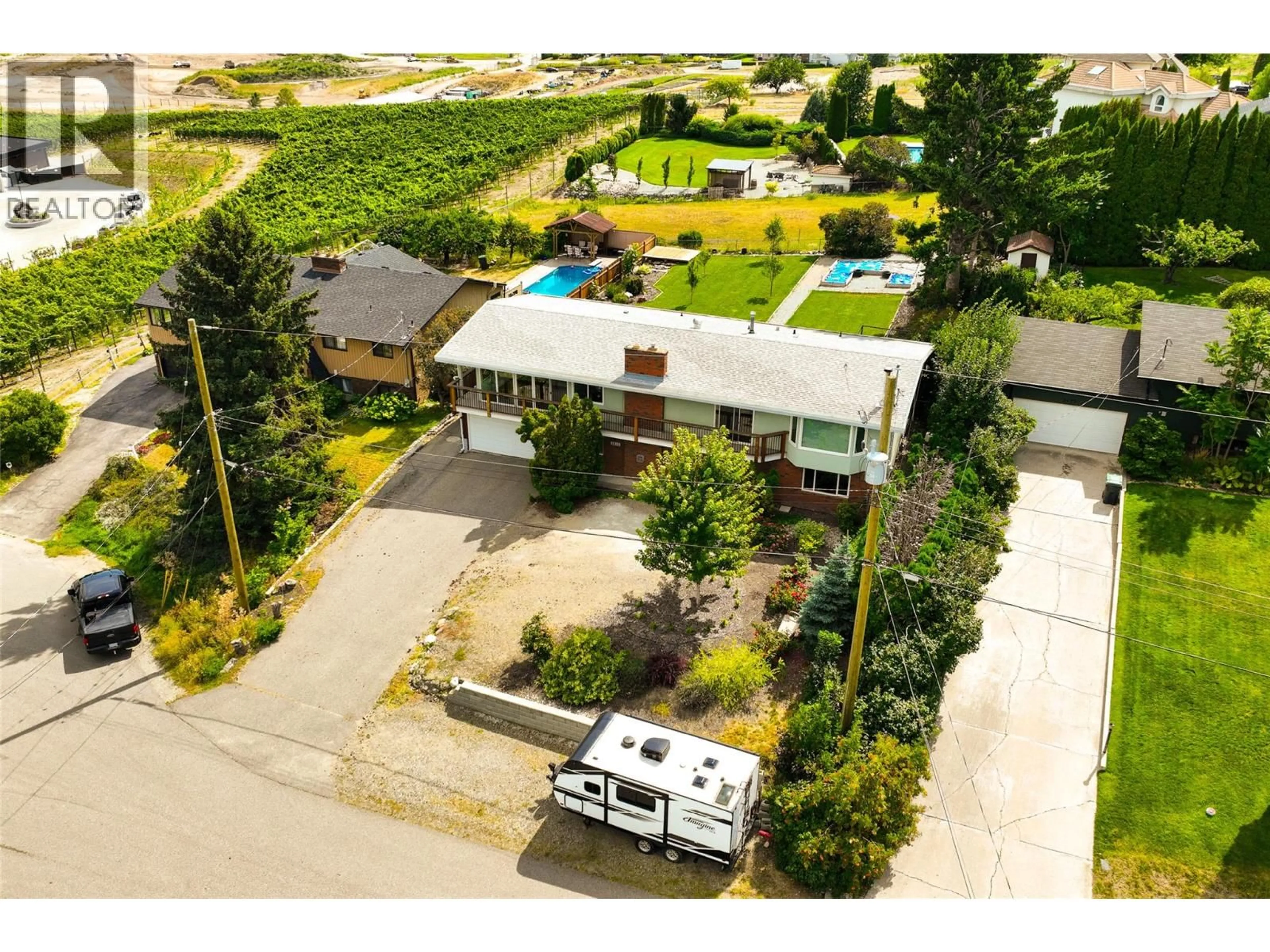 A pic from outside/outdoor area/front of a property/back of a property/a pic from drone, street for 2415 COLLINGWOOD ROAD, West Kelowna British Columbia V1Z2C3