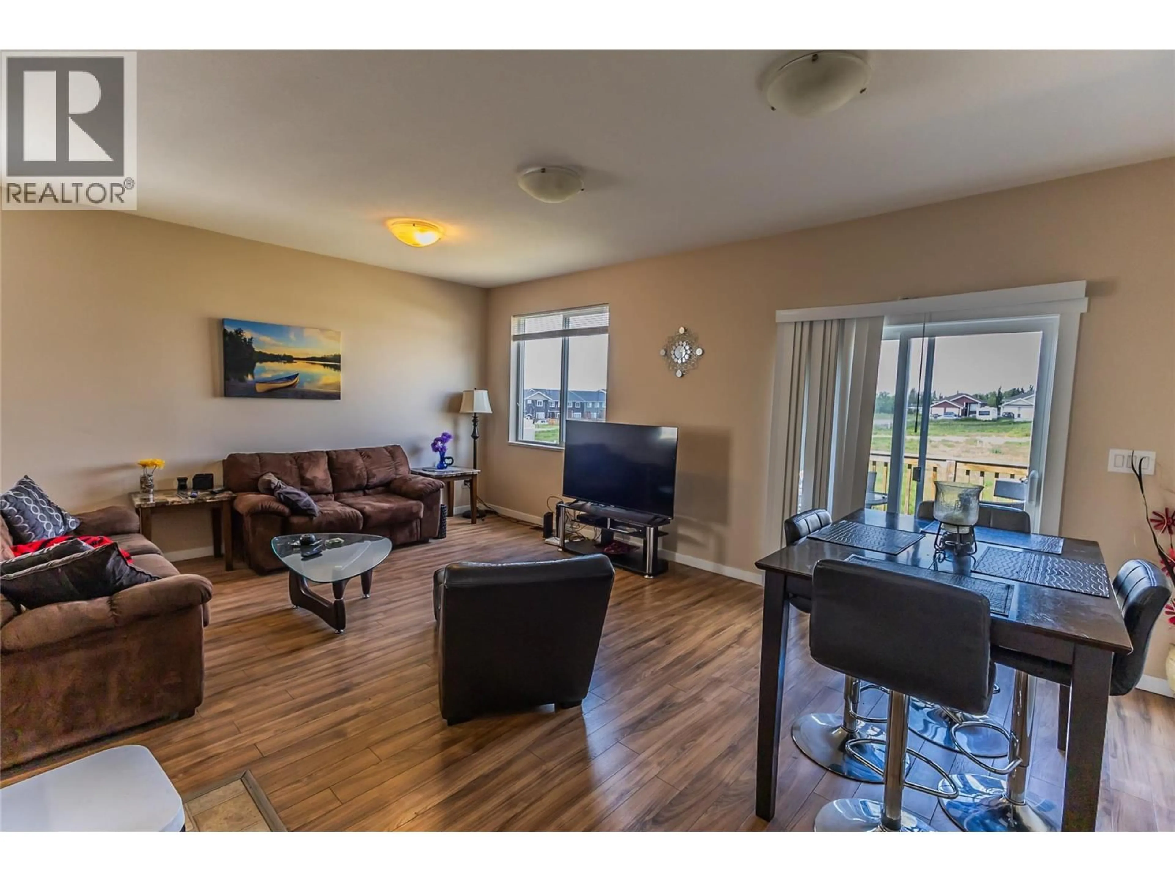 Living room with furniture, wood/laminate floor for 1708 84 AVENUE, Dawson Creek British Columbia V1G3L5