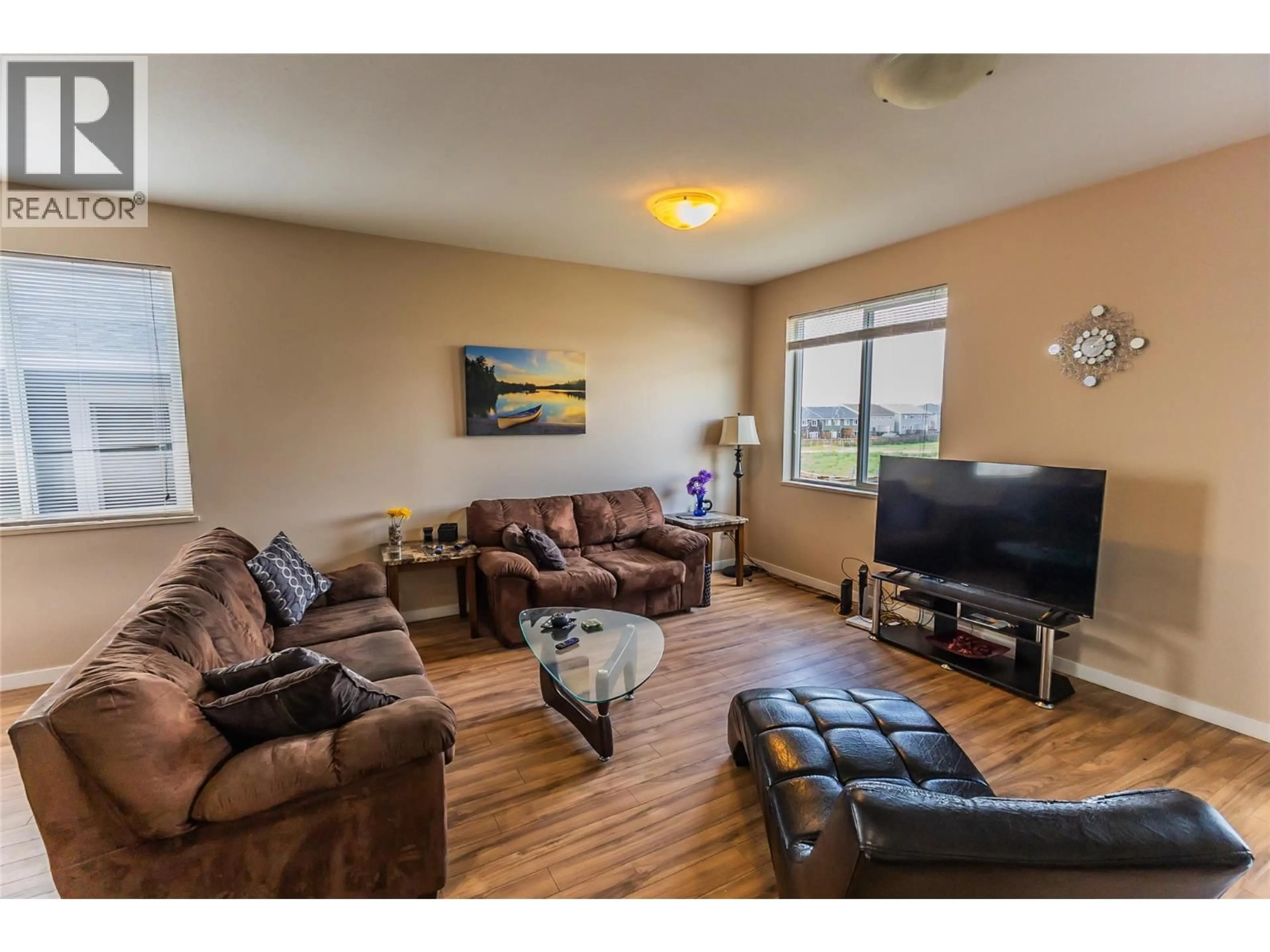 Living room with furniture, wood/laminate floor for 1708 84 AVENUE, Dawson Creek British Columbia V1G3L5