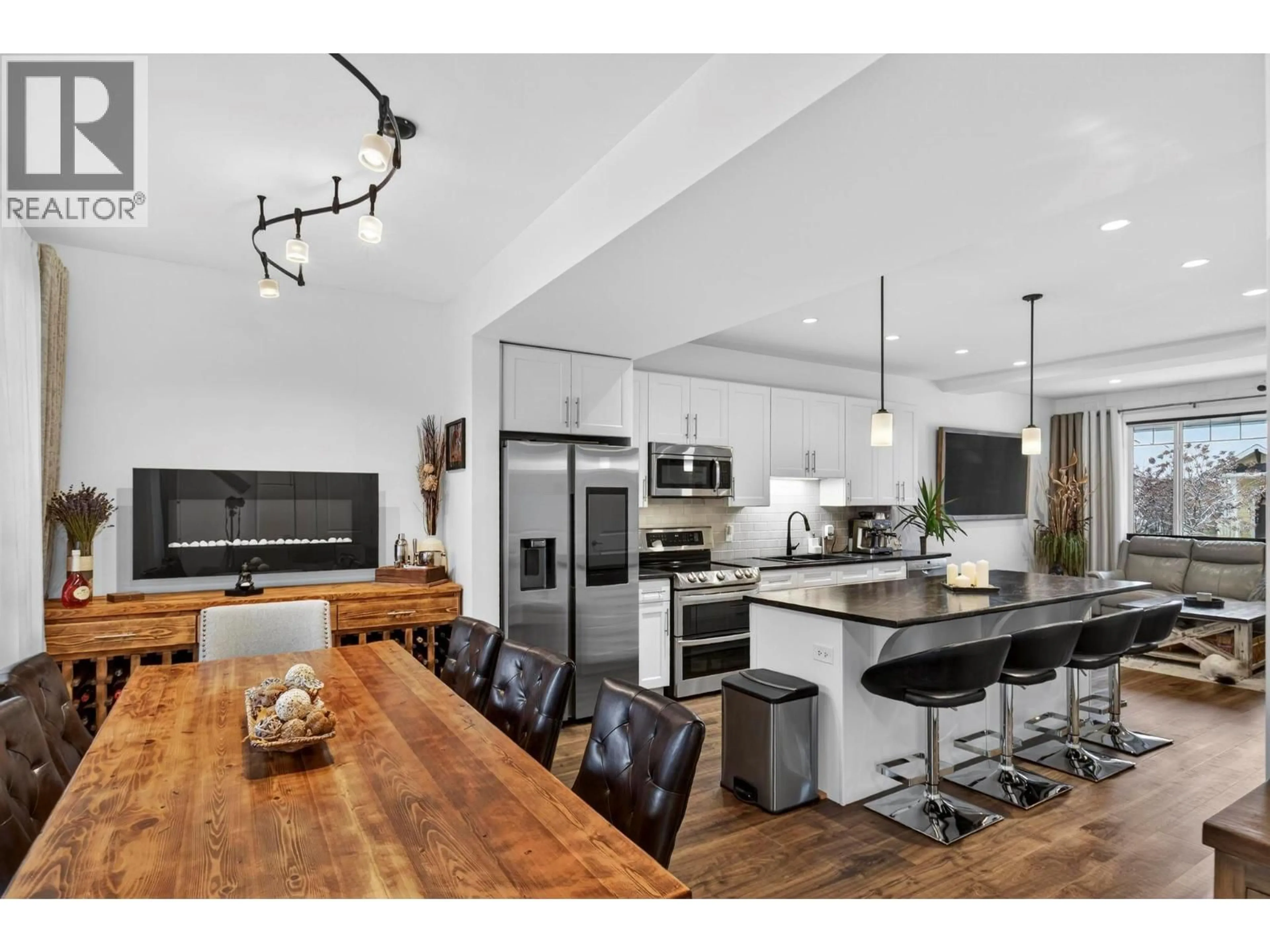 Open concept kitchen, wood/laminate floor for 1273 BERGAMOT AVENUE, Kelowna British Columbia V1W5K5