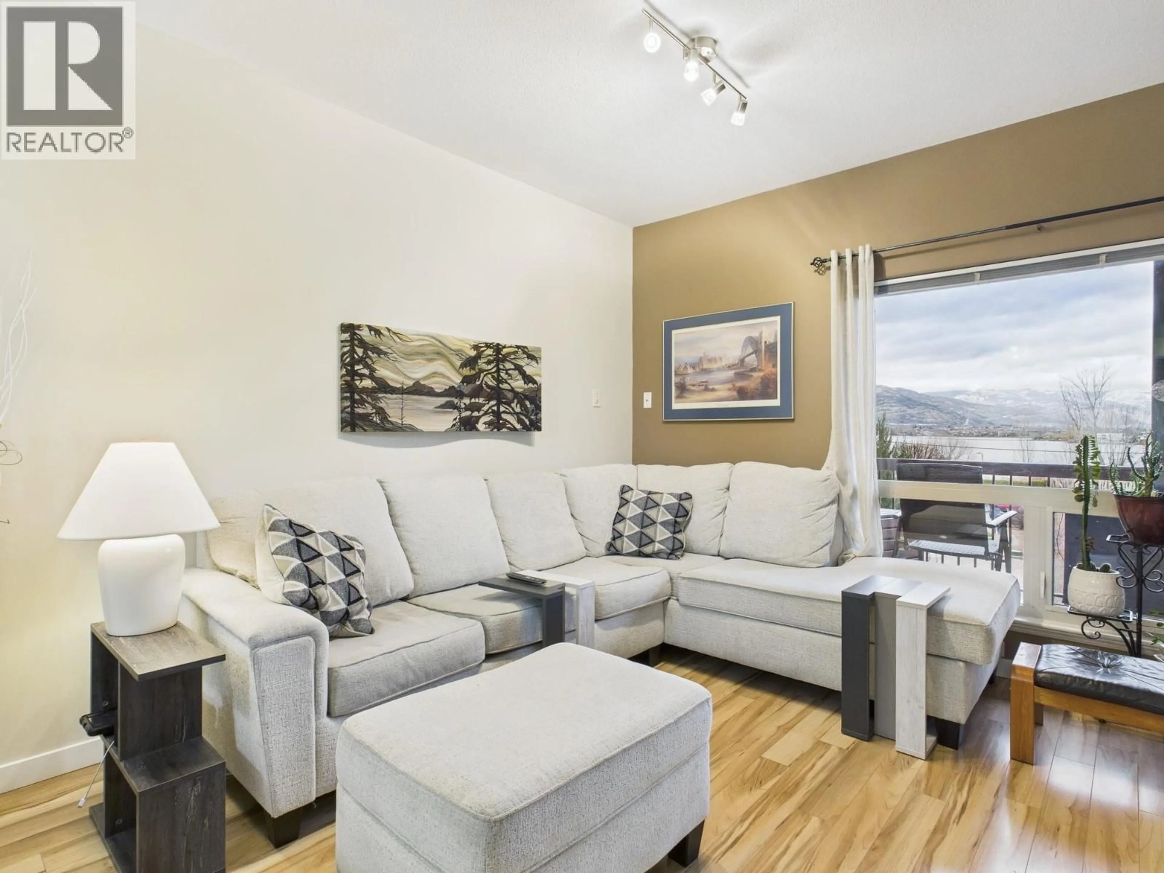 Living room with furniture, wood/laminate floor for 114 - 4300 44TH AVENUE, Osoyoos British Columbia V0H1V6