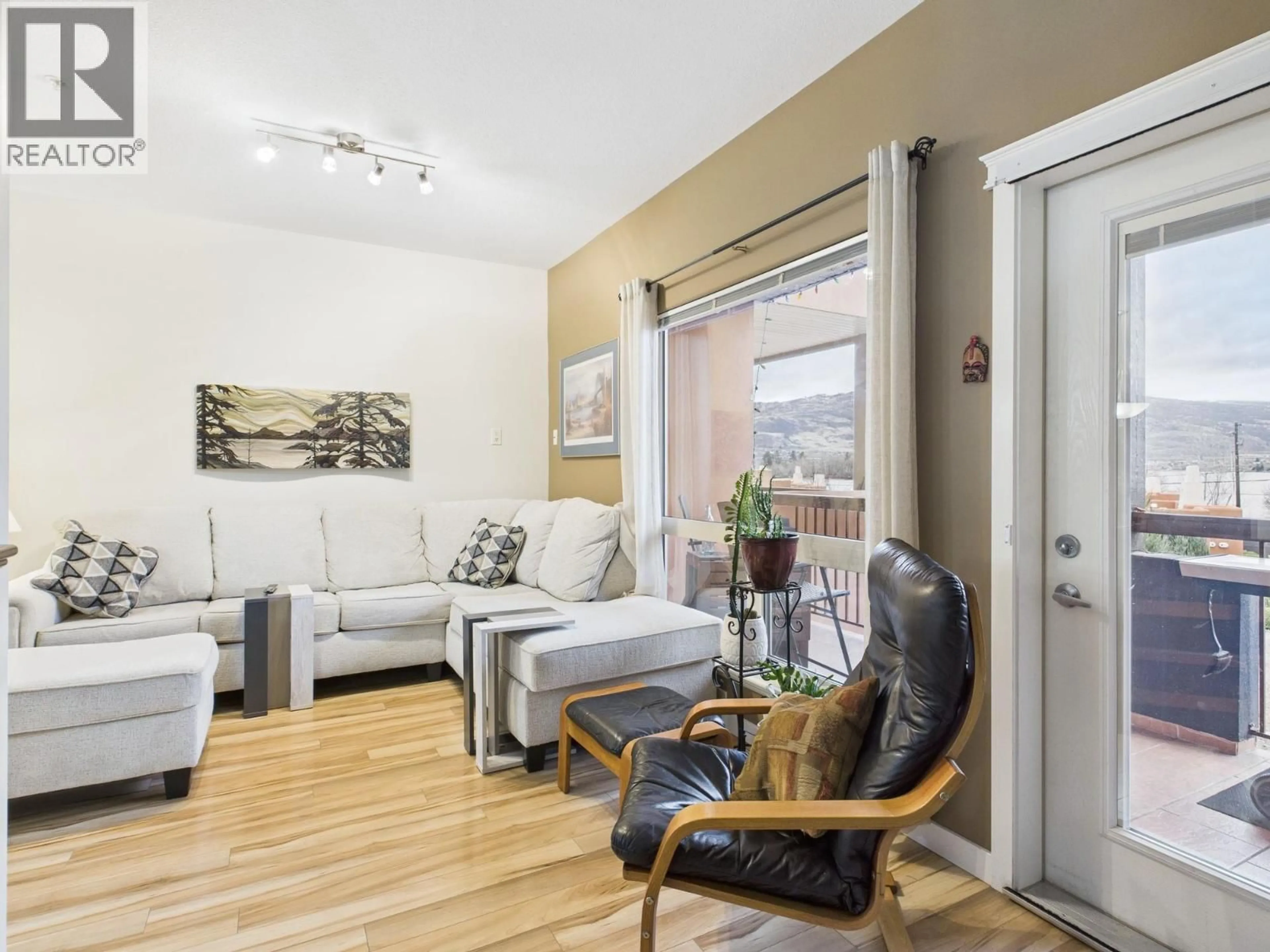 Living room with furniture, wood/laminate floor for 114 - 4300 44TH AVENUE, Osoyoos British Columbia V0H1V6