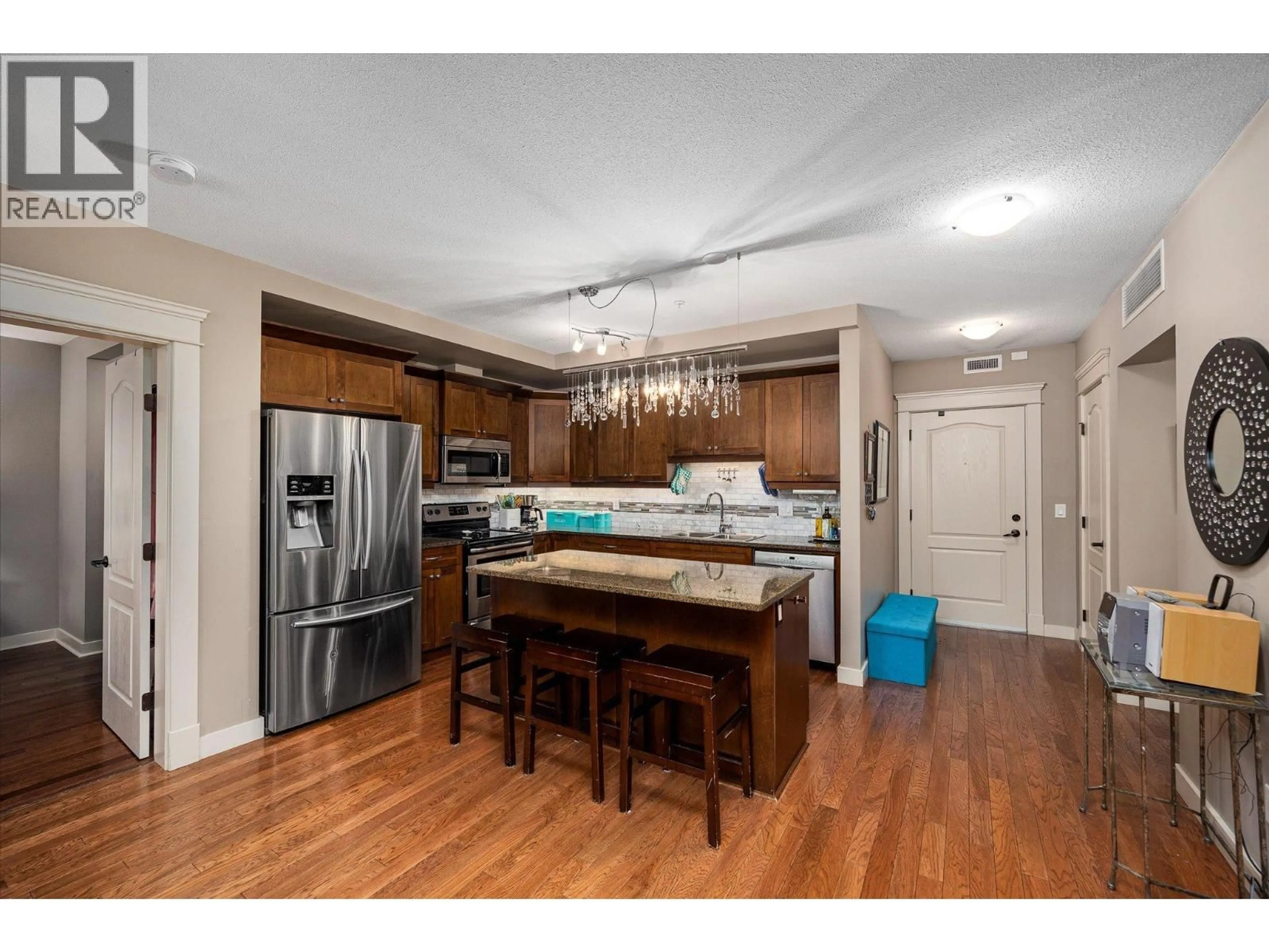 Open concept kitchen, wood/laminate floor for 403 - 2070 BOUCHERIE ROAD, Westbank British Columbia V4T2C6