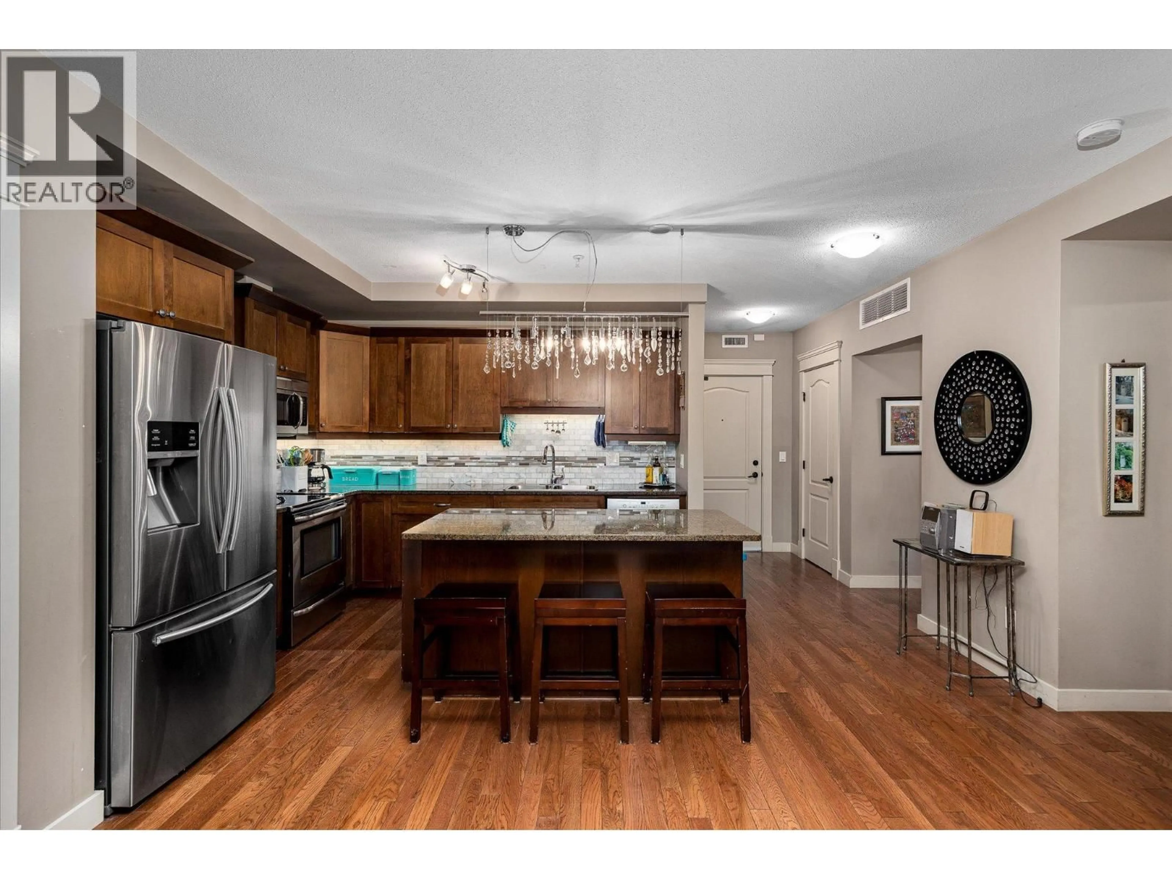 Open concept kitchen, wood/laminate floor for 403 - 2070 BOUCHERIE ROAD, Westbank British Columbia V4T2C6