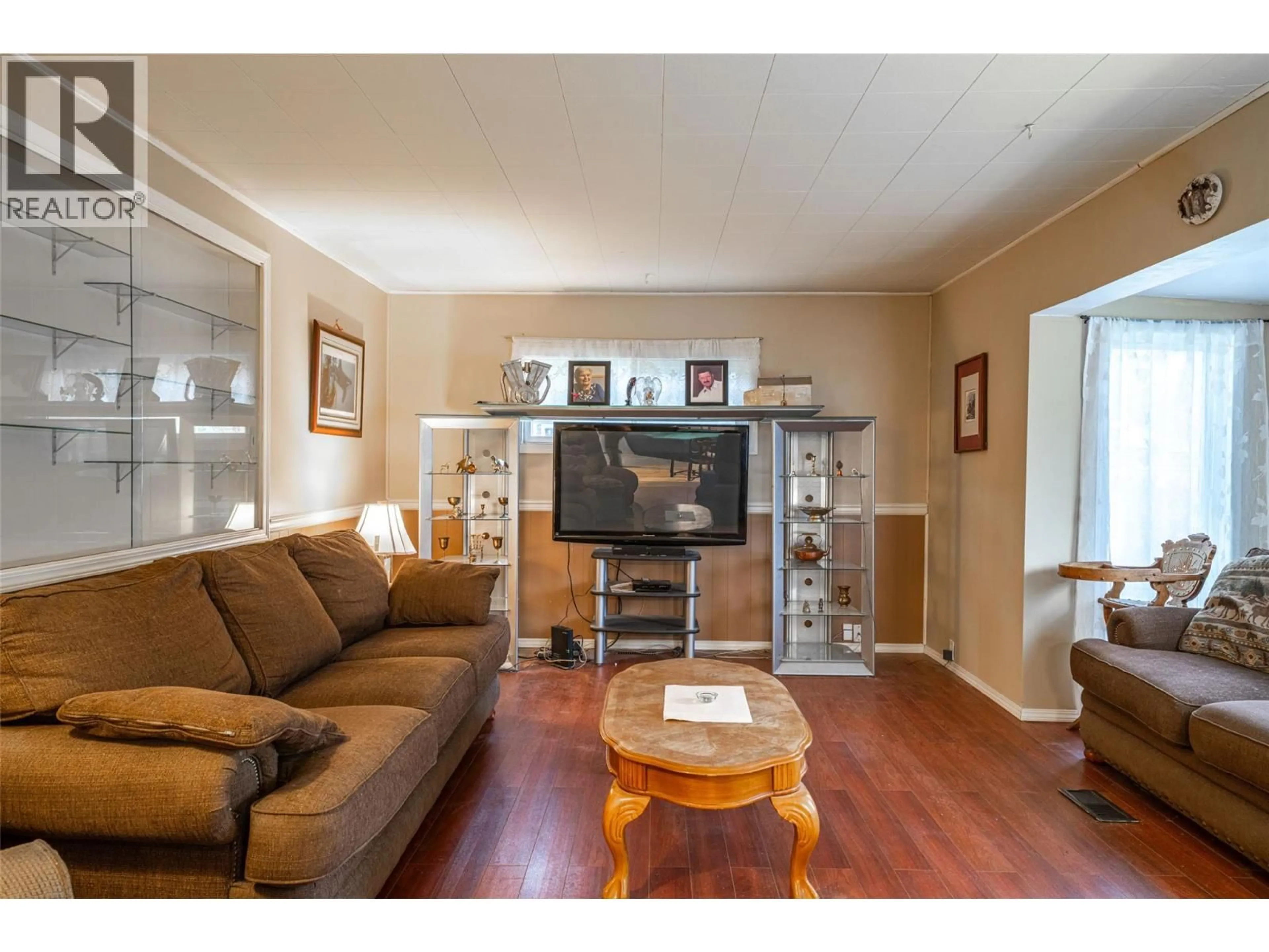 Living room with furniture, wood/laminate floor for 5714 PONDEROSA ROAD, Falkland British Columbia V0E1W0