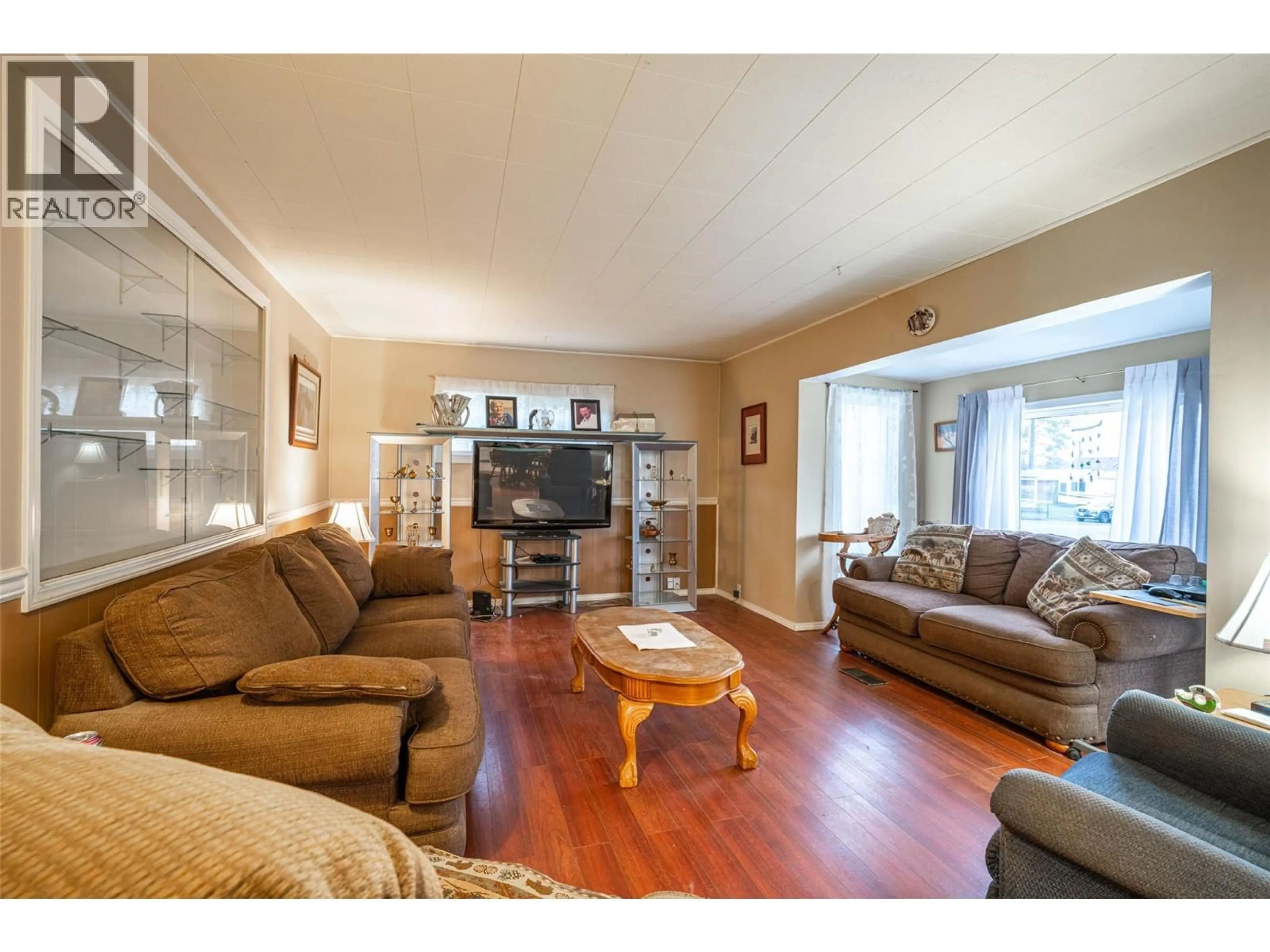 Living room with furniture, wood/laminate floor for 5714 PONDEROSA ROAD, Falkland British Columbia V0E1W0