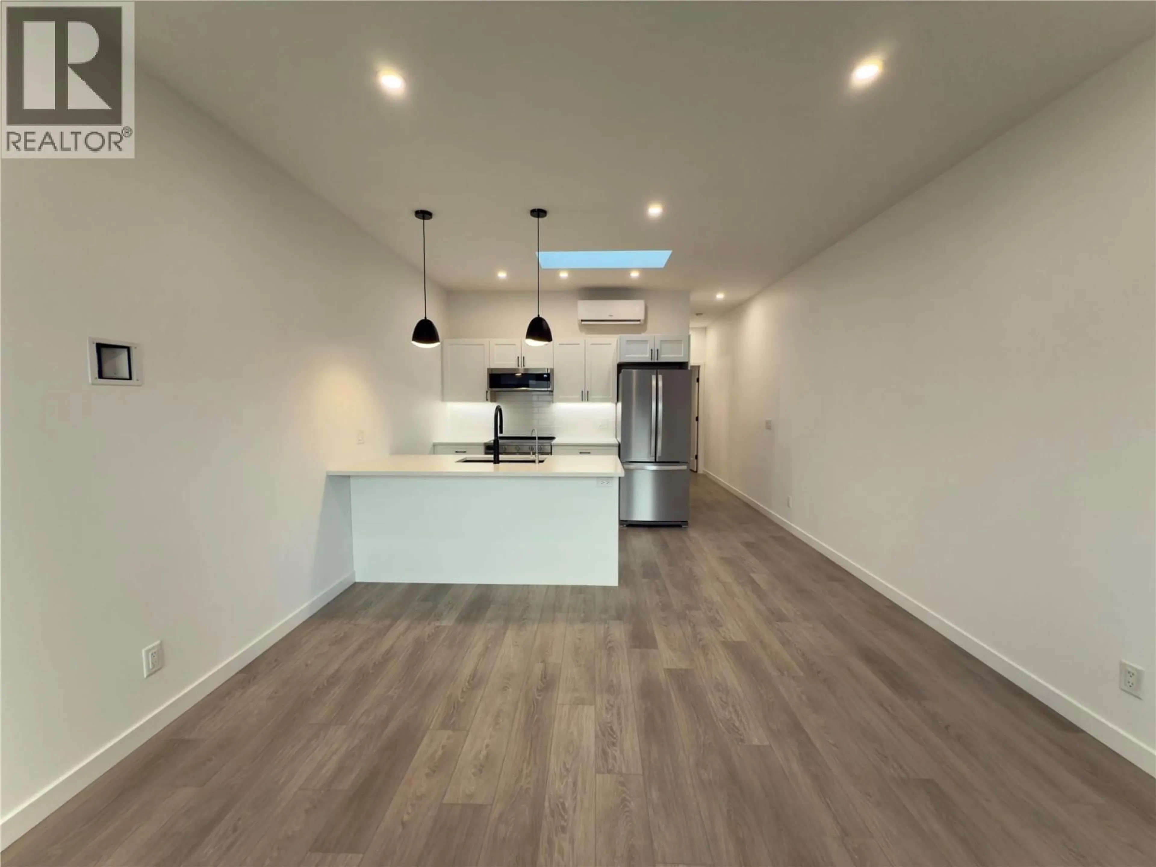 Open concept kitchen, wood/laminate floor for 23E - 8900 JIM BAILEY ROAD, Kelowna British Columbia V4V0B5
