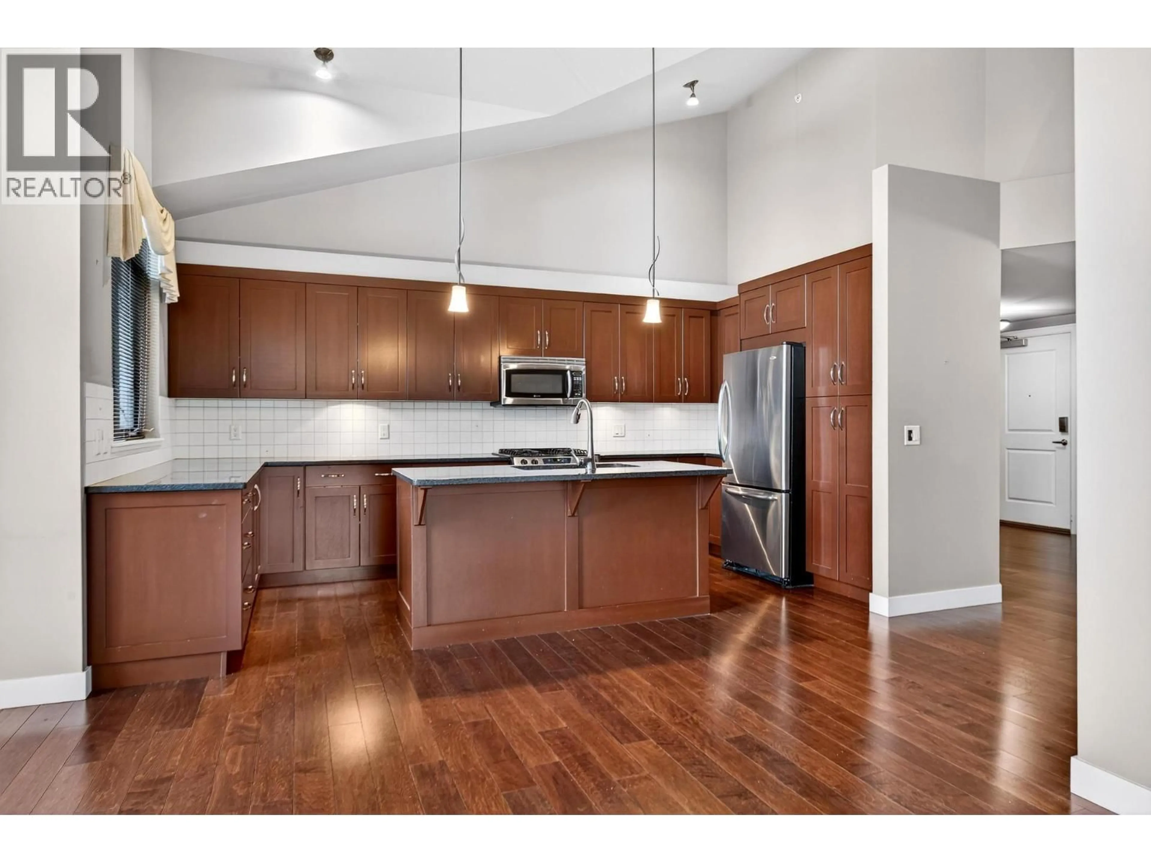 Open concept kitchen, wood/laminate floor for 203 - 600 SARSONS ROAD, Kelowna British Columbia V1W5H5