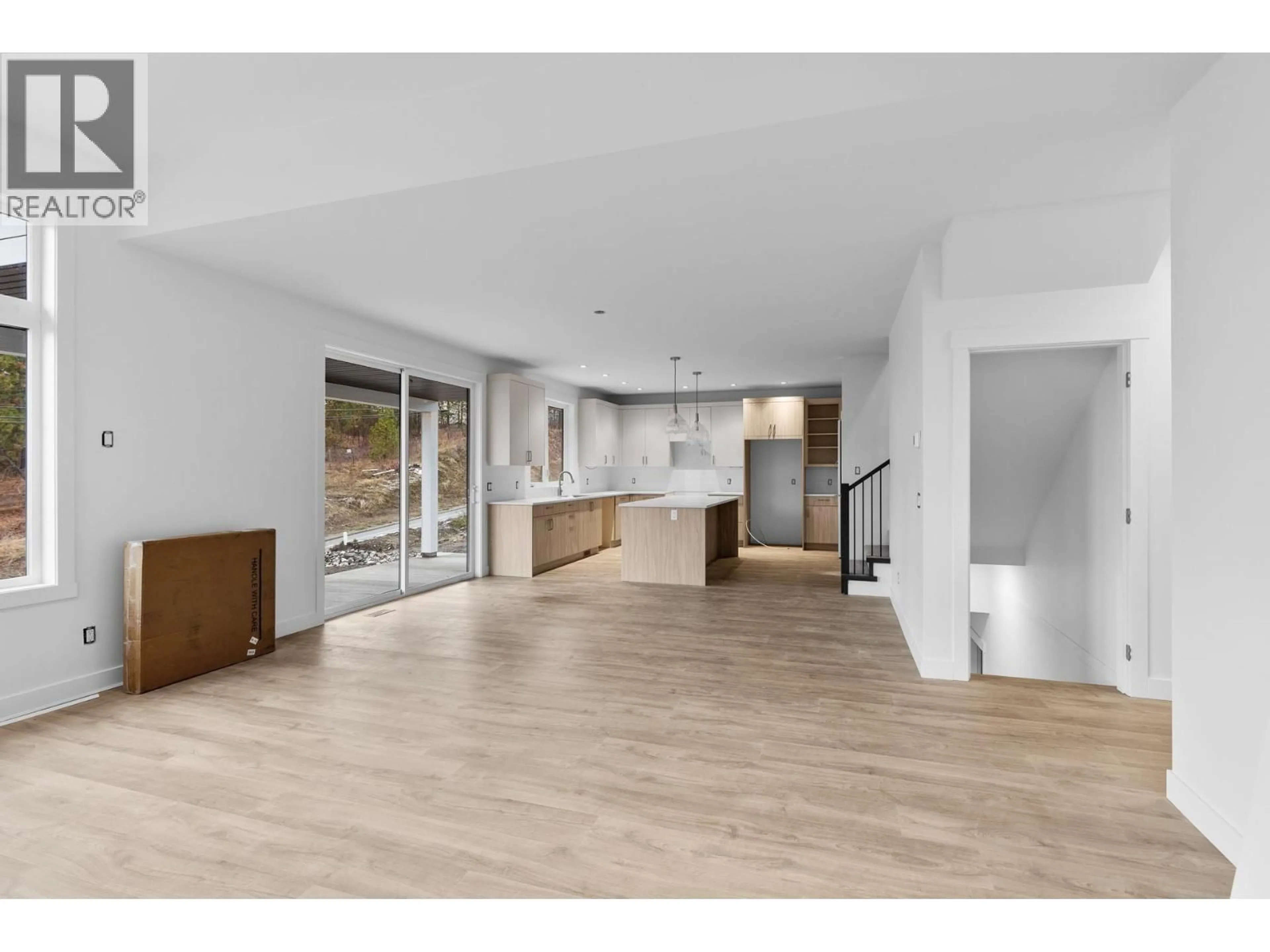 Open concept kitchen, wood/laminate floor for 2208 SURREY ROAD, West Kelowna British Columbia V1Z2L3