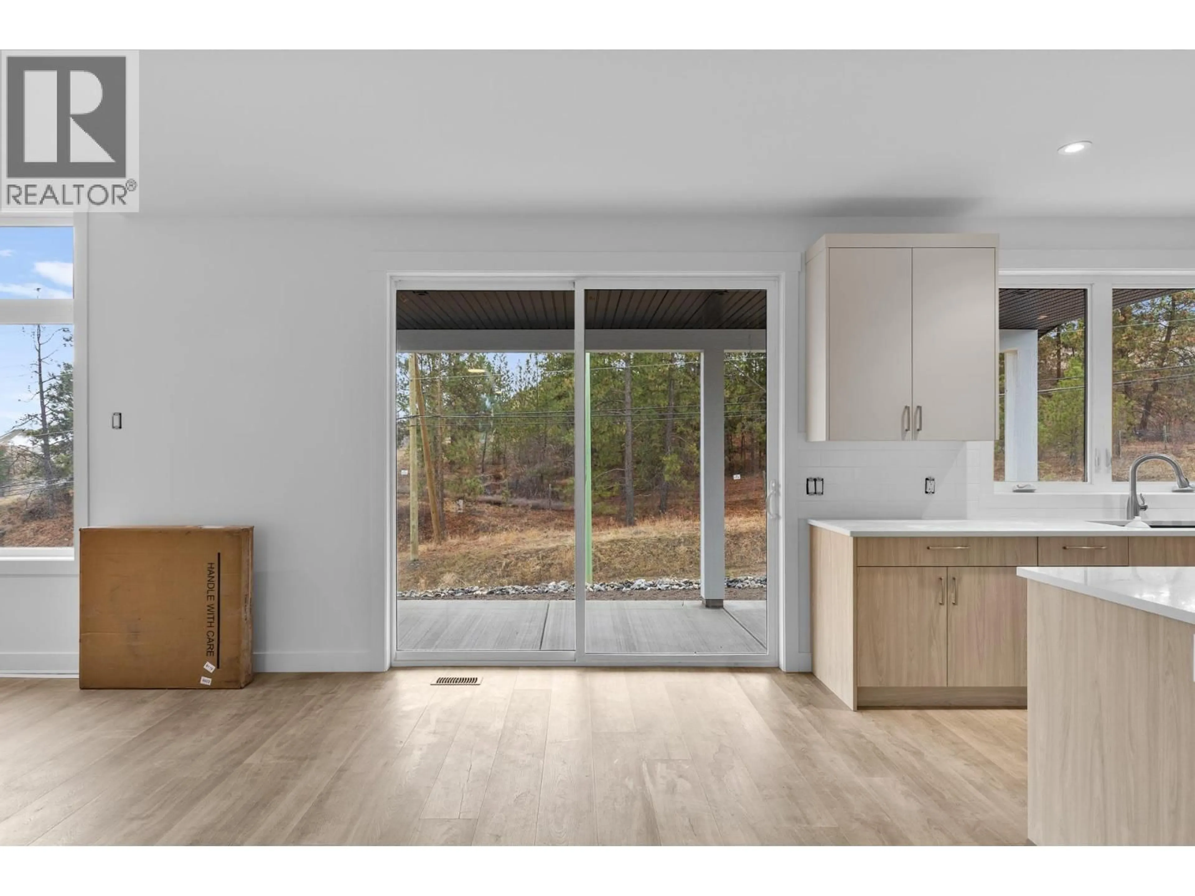 Open concept kitchen, wood/laminate floor for 2208 SURREY ROAD, West Kelowna British Columbia V1Z2L3