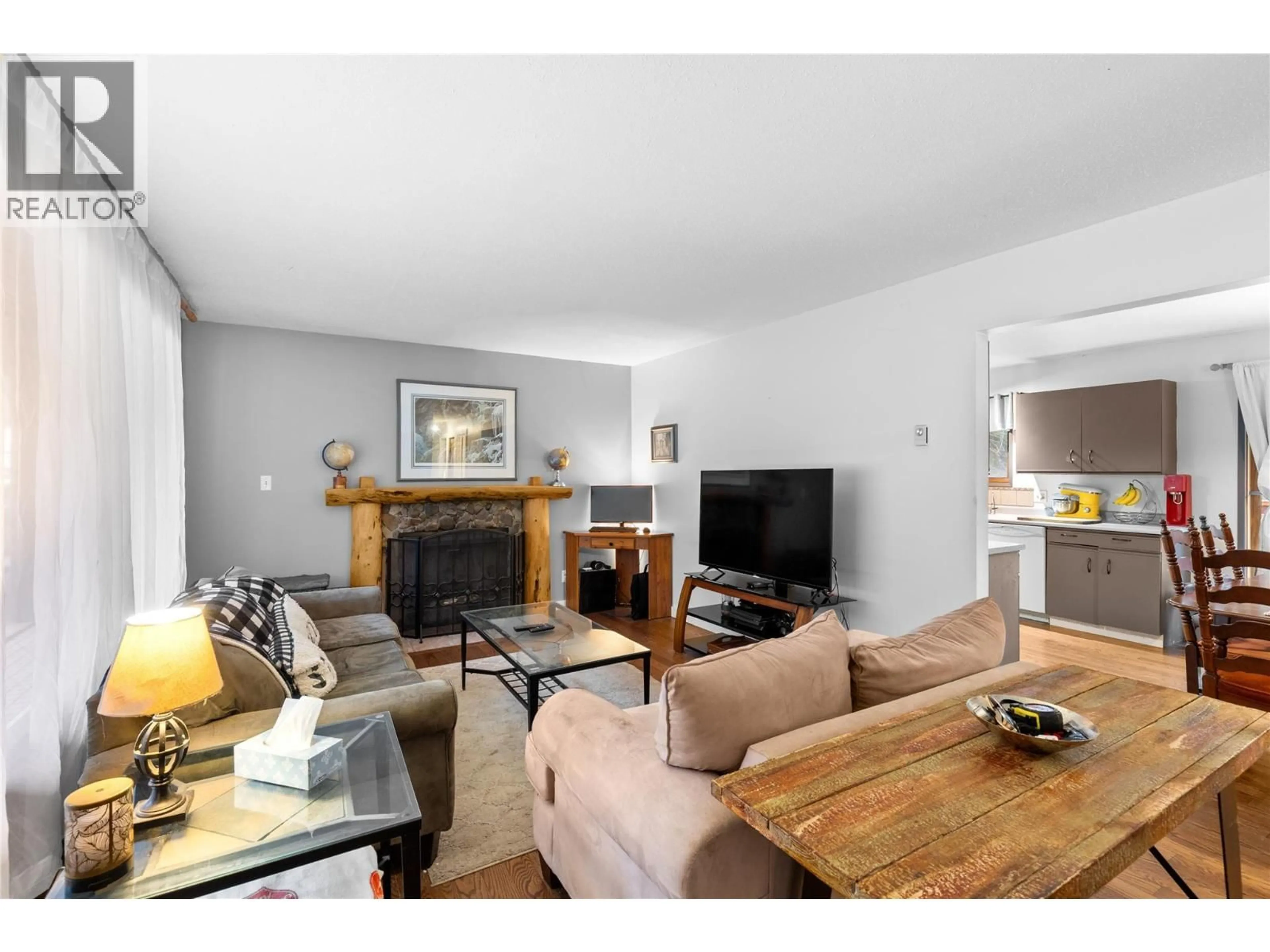 Living room with furniture, wood/laminate floor for 327 EVERGREEN WAY, Vernon British Columbia V1H2B8