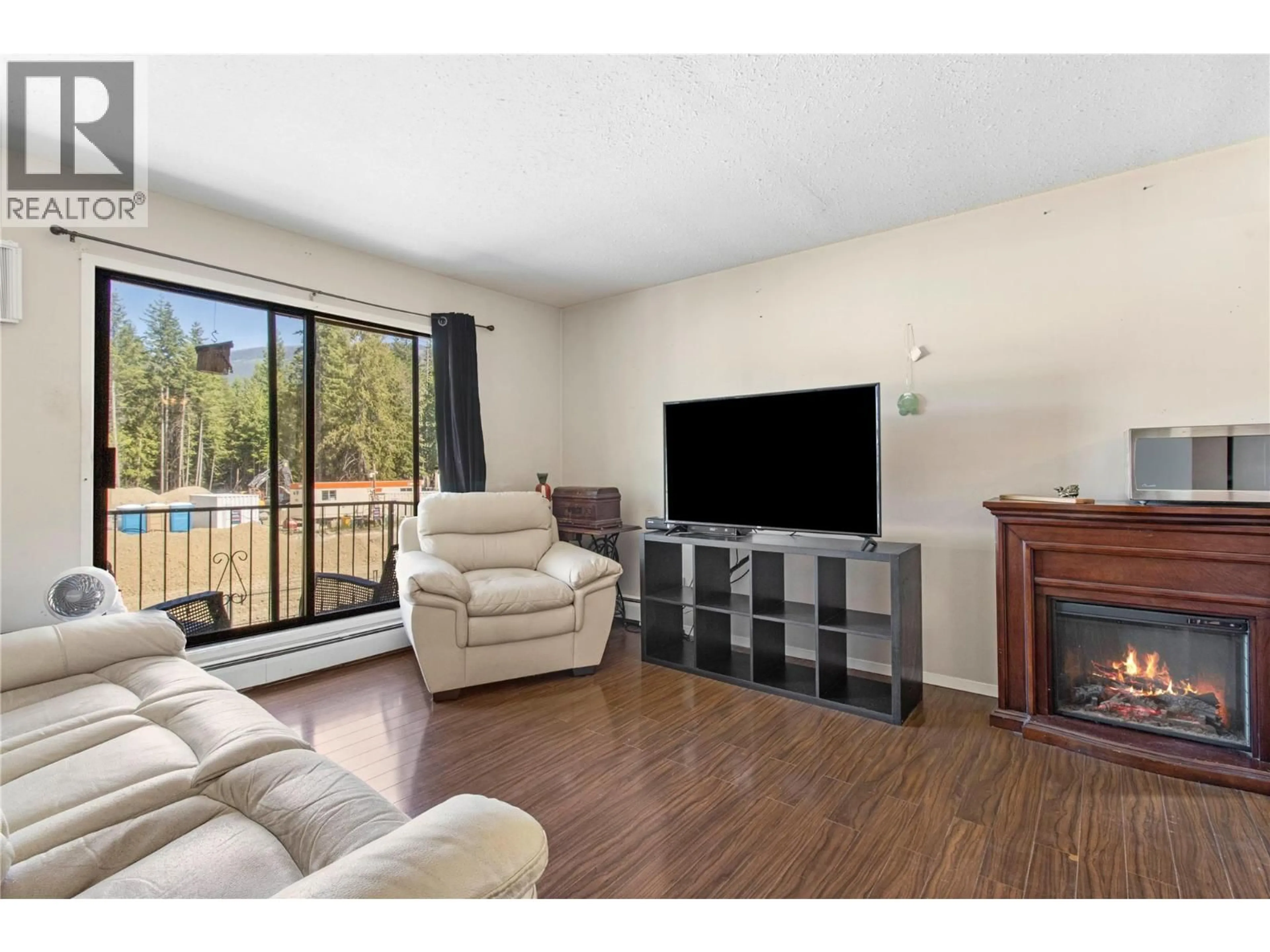 Living room with furniture, wood/laminate floor for 204 - 409 MAIN STREET, Sicamous British Columbia V0E2V0