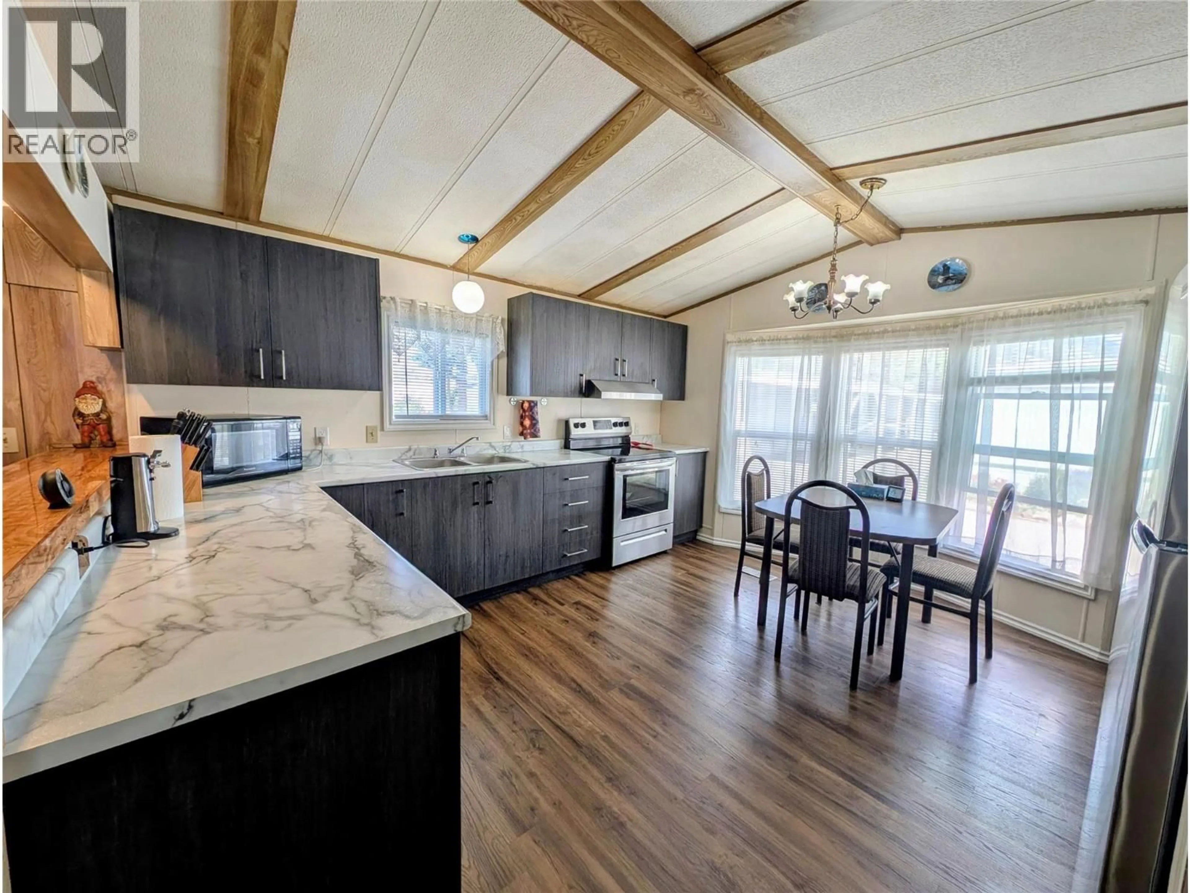 Open concept kitchen, wood/laminate floor for 122 - 1401 NICOLA AVENUE, Merritt British Columbia V1K1L8