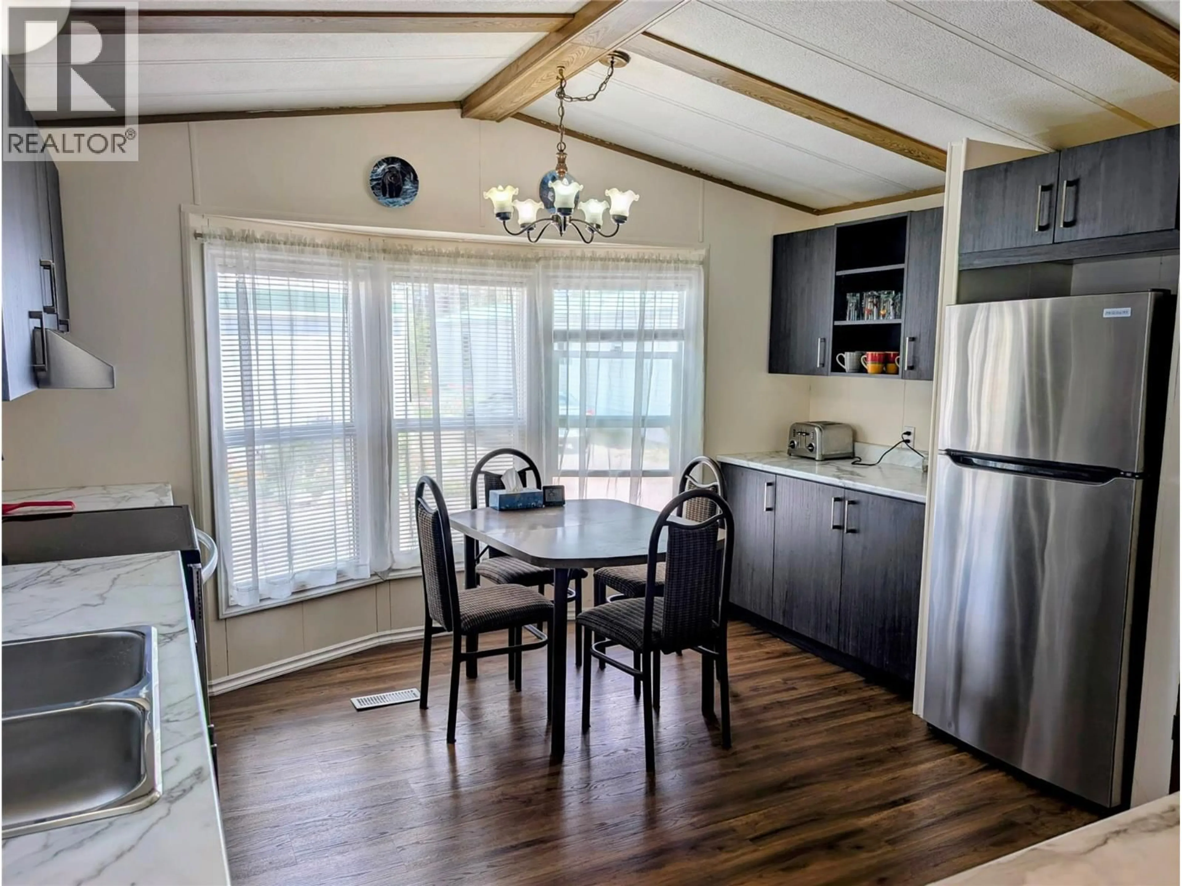 Open concept kitchen, wood/laminate floor for 122 - 1401 NICOLA AVENUE, Merritt British Columbia V1K1L8